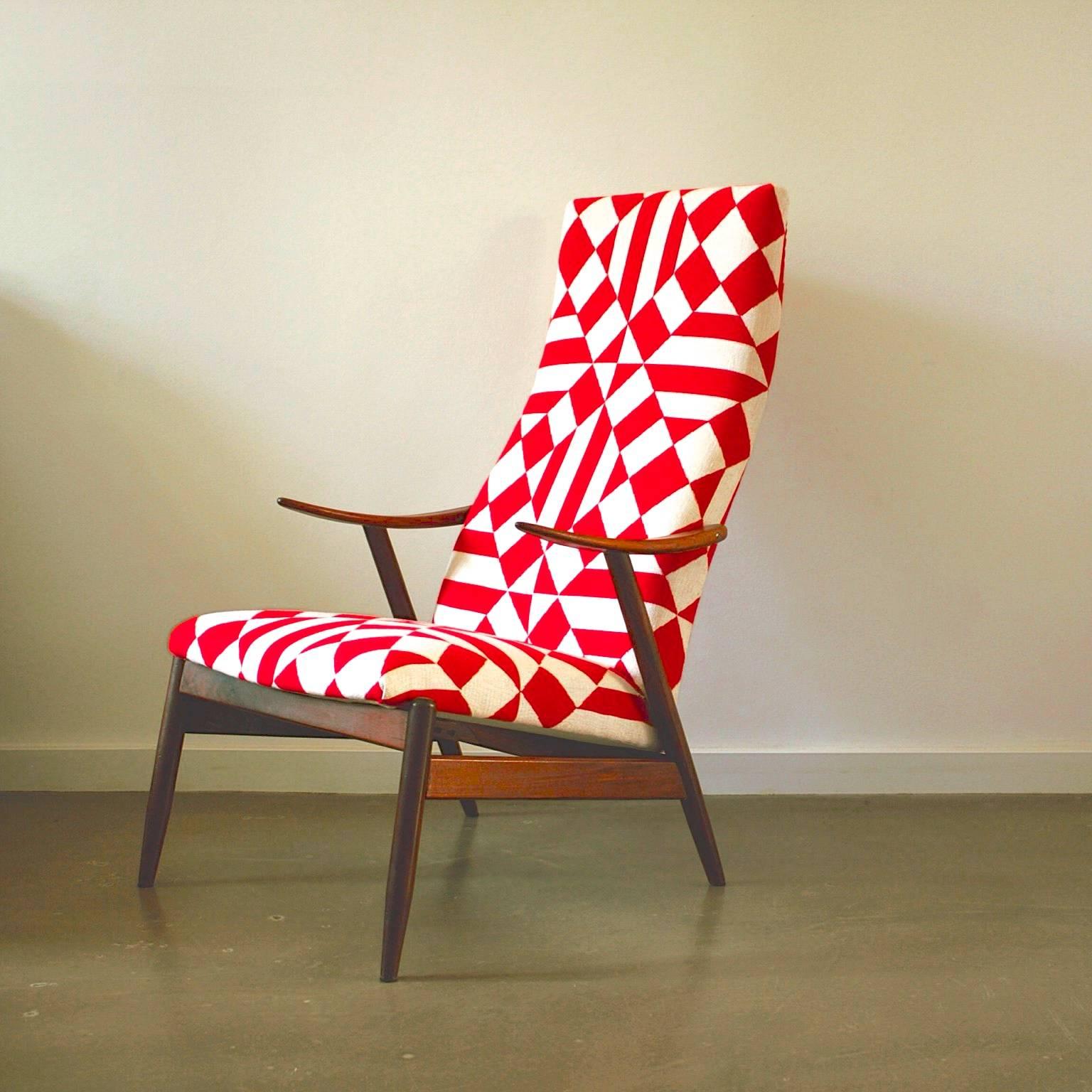 This high back lounge chair was designed and produced in Denmark. It is made from teak with a red and white abstract patterned fabric. It is newly upholstered.