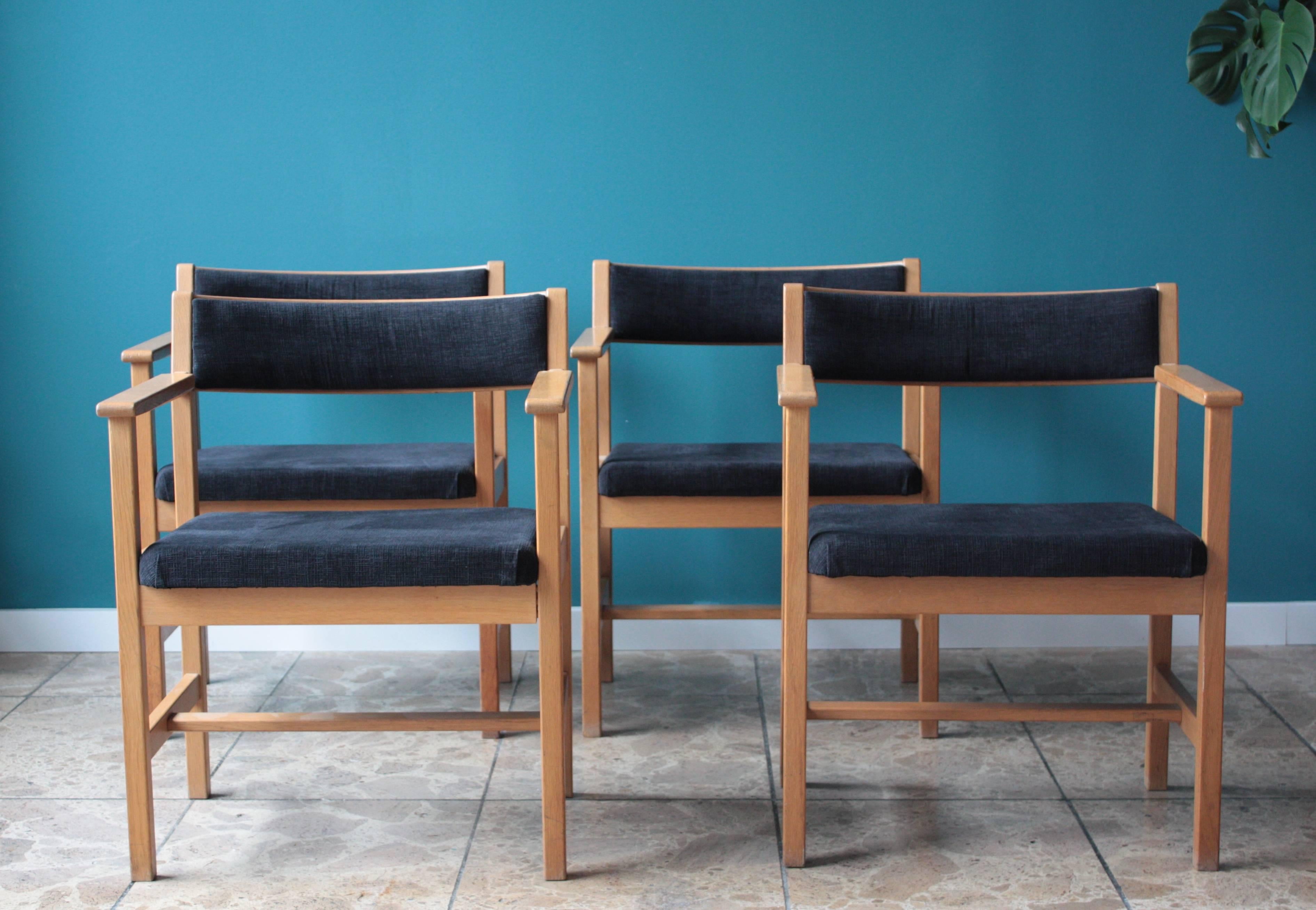 This set of four dining chairs model 3242 was designed by Børge Mogensen and produced by Fredericia in Denmark. They feature oak frames and a dark blue upholstery.