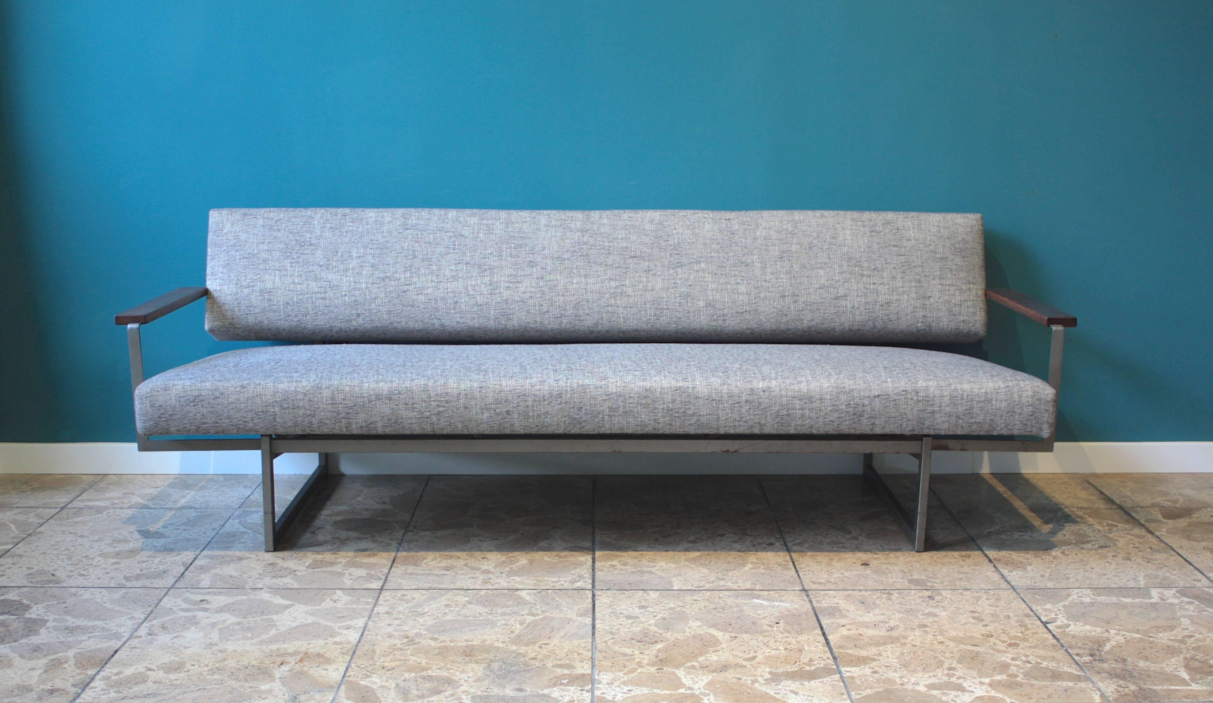This sofa was designed by Rob Parry and produced by Gelderland in the Netherlands in the 1950s. It has a metal frame and wooden armrests made of wenge. It can be converted into a daybed (see photos). It has been entirely reupholstered.