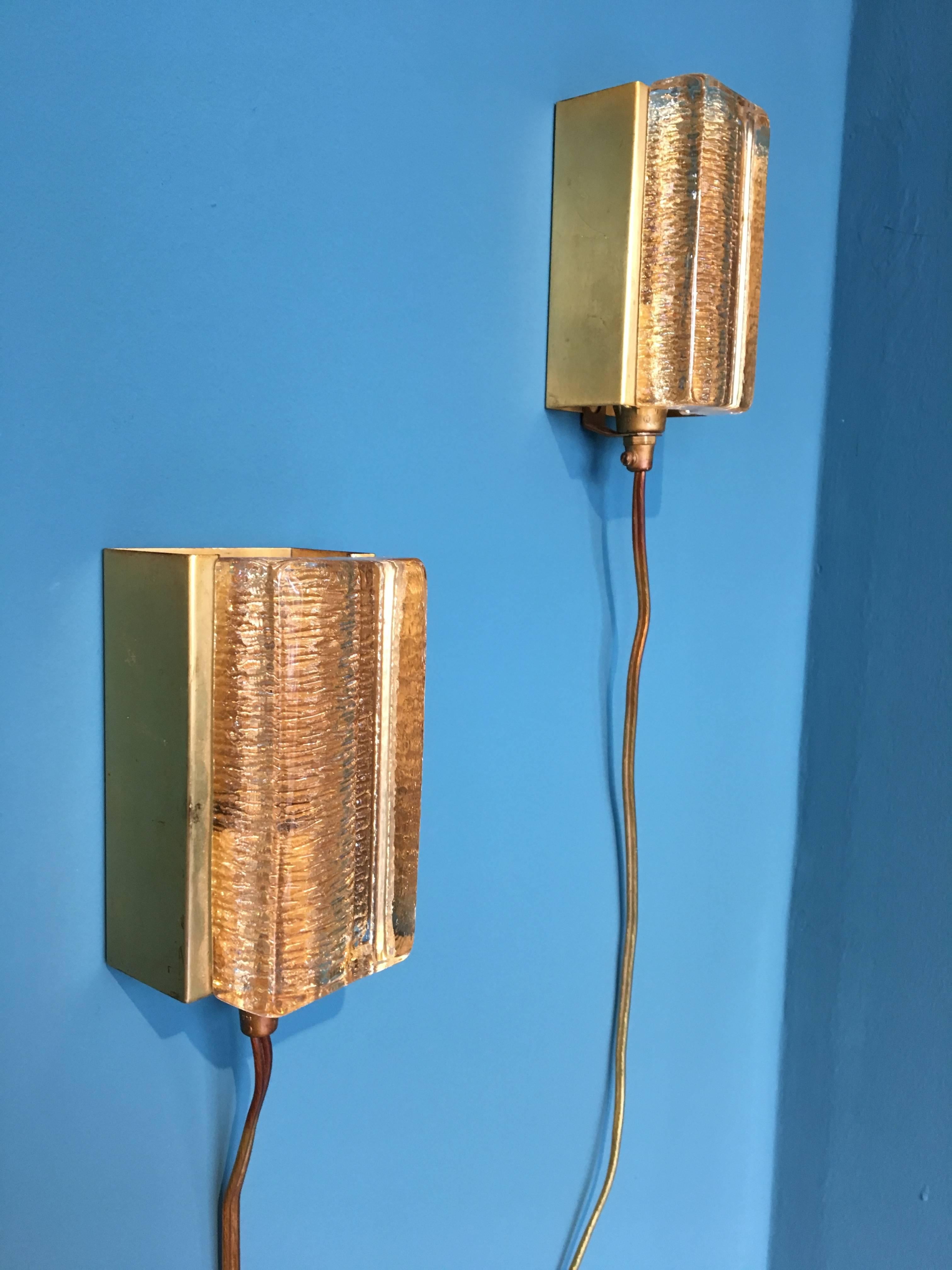 This pair of small wall lamps was produced by Danish company Vitrika in the 1970s. The lamps are made of brass and glass. European wiring.