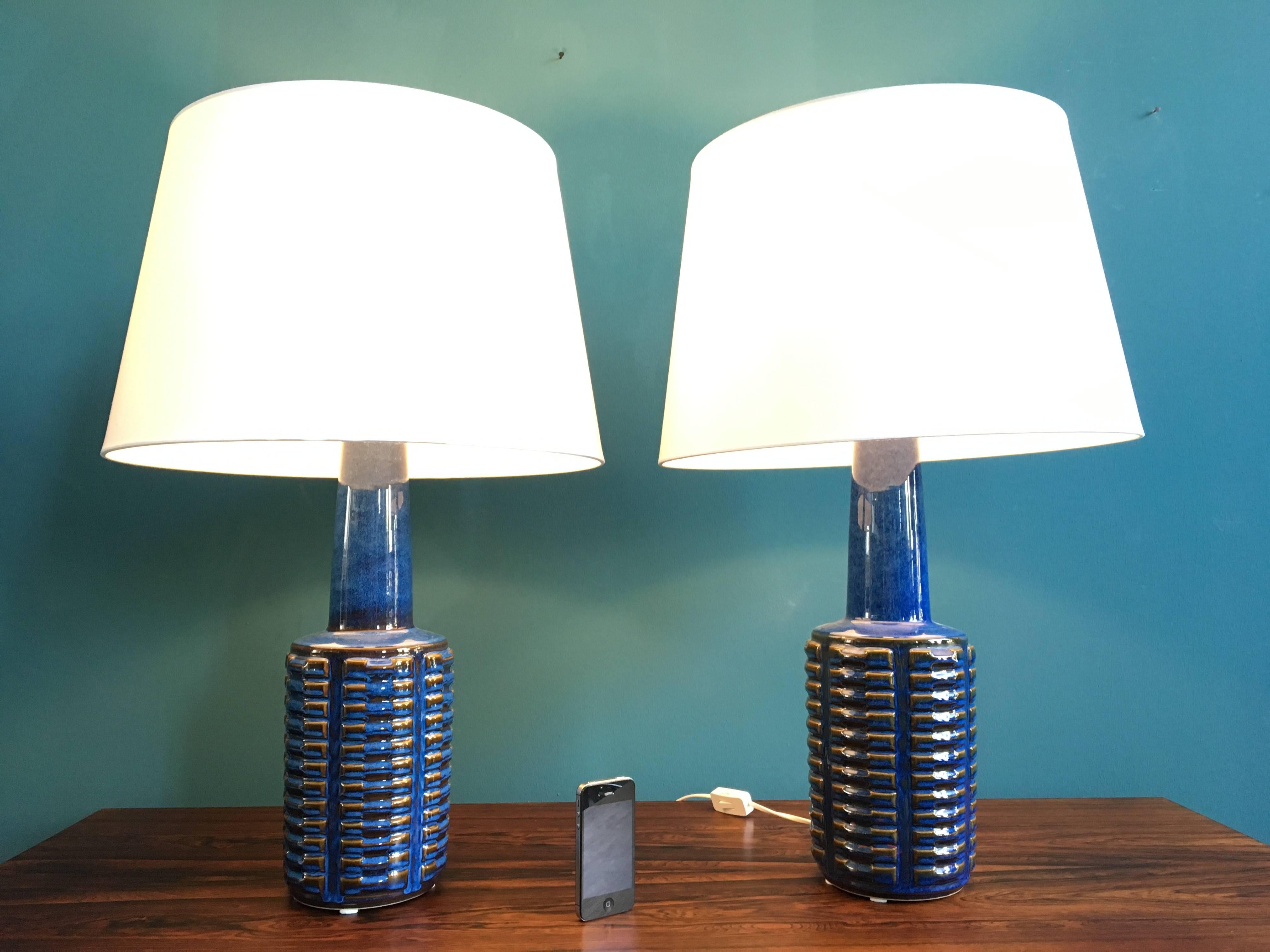 This pair of ceramic table lamps was designed by Einar Johansen and produced by Soholm Stentoj in Denmark in the 1960s. The lamps have been rewired with switches and have new sockets and shades. New European wiring and plugs. 
Søholm was founded in