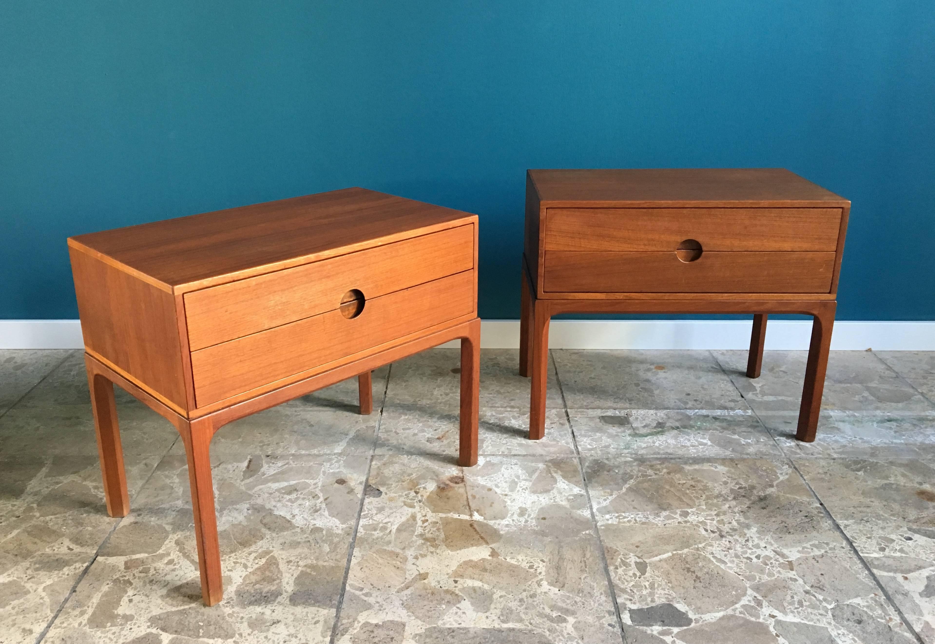 Nice pair of night cabinets designed by Aksel Kjersgaard and manufactured by Odder Mobelfabrik, Denmark, 1955. This set of cabinets is made of teak wood and has very nice Danish lines. One cabinet has two drawers; the other one has two folding