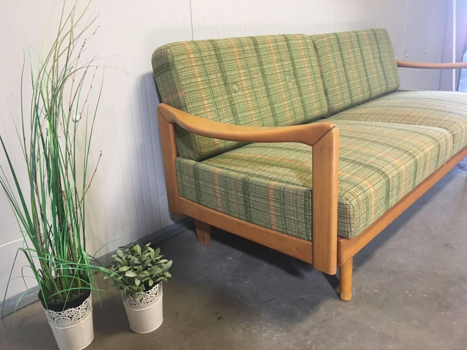 Midcentury day d/sofa designed by Walter Knoll. Designed and produced in the 1950s. When you extend the sofa and move the pillows, this sofa becomes a daybed. 

In original condition. Pillows are in excellent condition and very firm. Wood also in