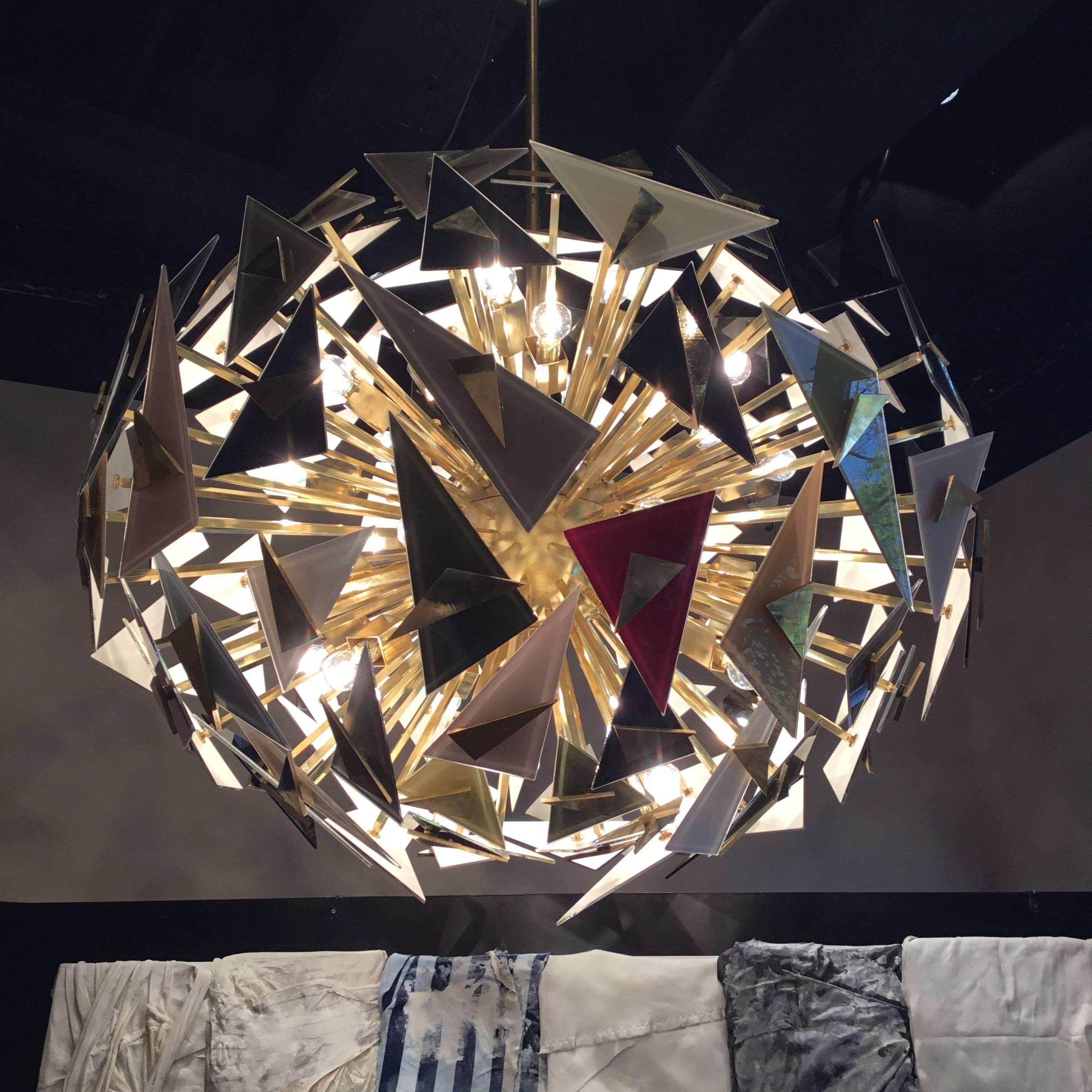 Vintage Italian chandelier, handcraft by a Venetian craftman with the famous venetian glass.
composed of a brass structure with numerous triangles of different shapes and colors at the end
Made in Italy, 1990 circa