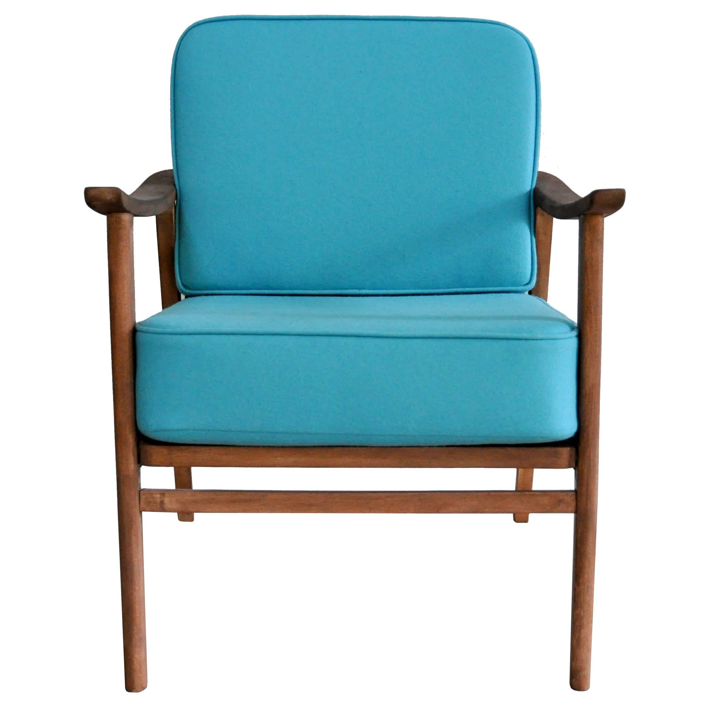 This easy chair from the 1950s is made out of beech. Foam cushions have been recently upholstered with wool felt fabric. 

There are two identical chairs in stock. This offer refers to option one: Sandpapered beech, stained red-brown, turquoise