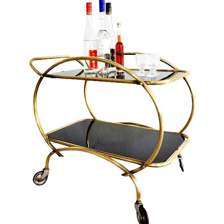 Vintage piece in excellent condition.
This cocktail or serving cart is made out of brass and black glass.
 