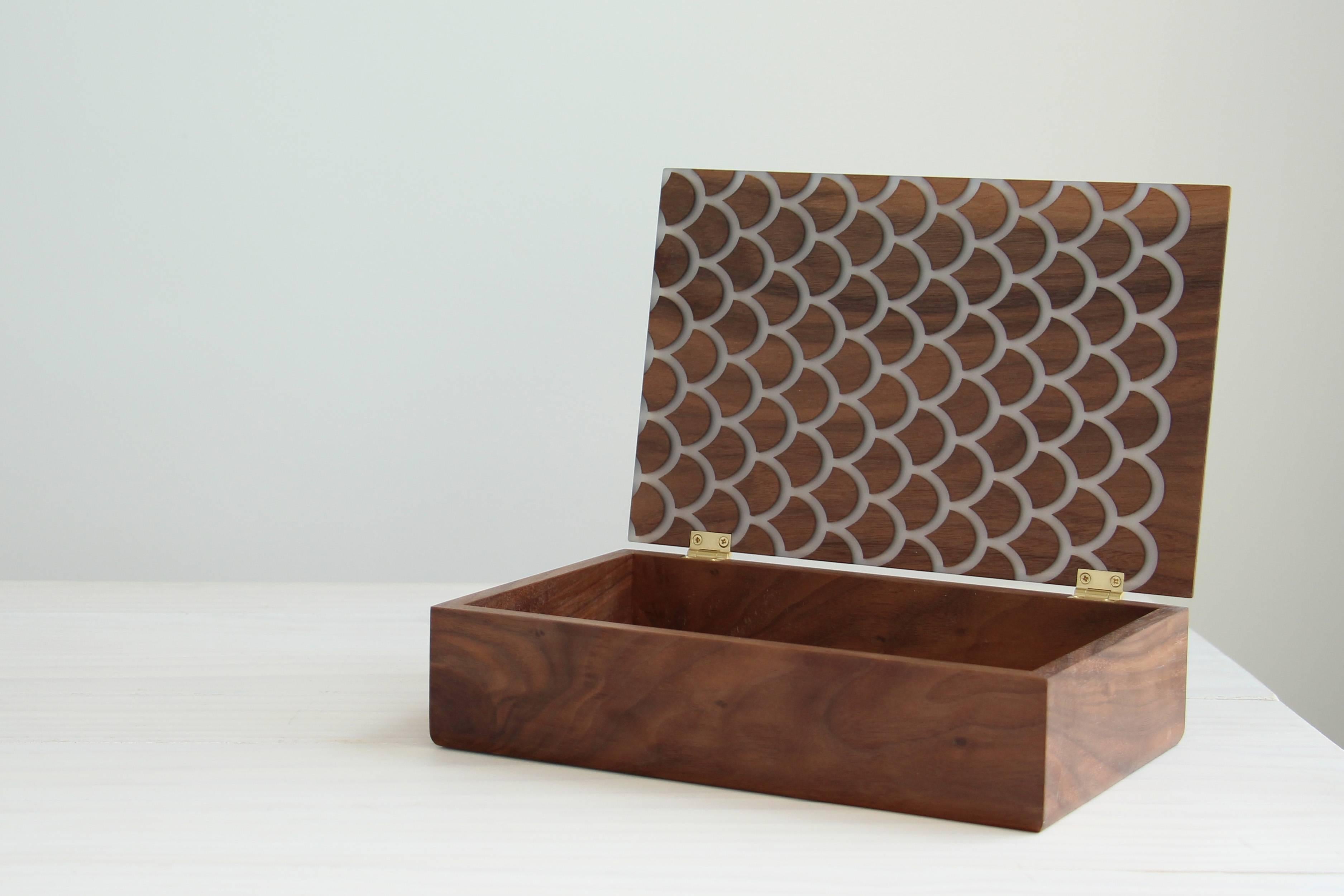 This limited edition treasure box is made from solid American walnut with inlaid resin in our Koi design.

Inspired by the scales of Japanese ornamental fish, the Koi pattern is carved straight through the wood to capture the light, giving the resin