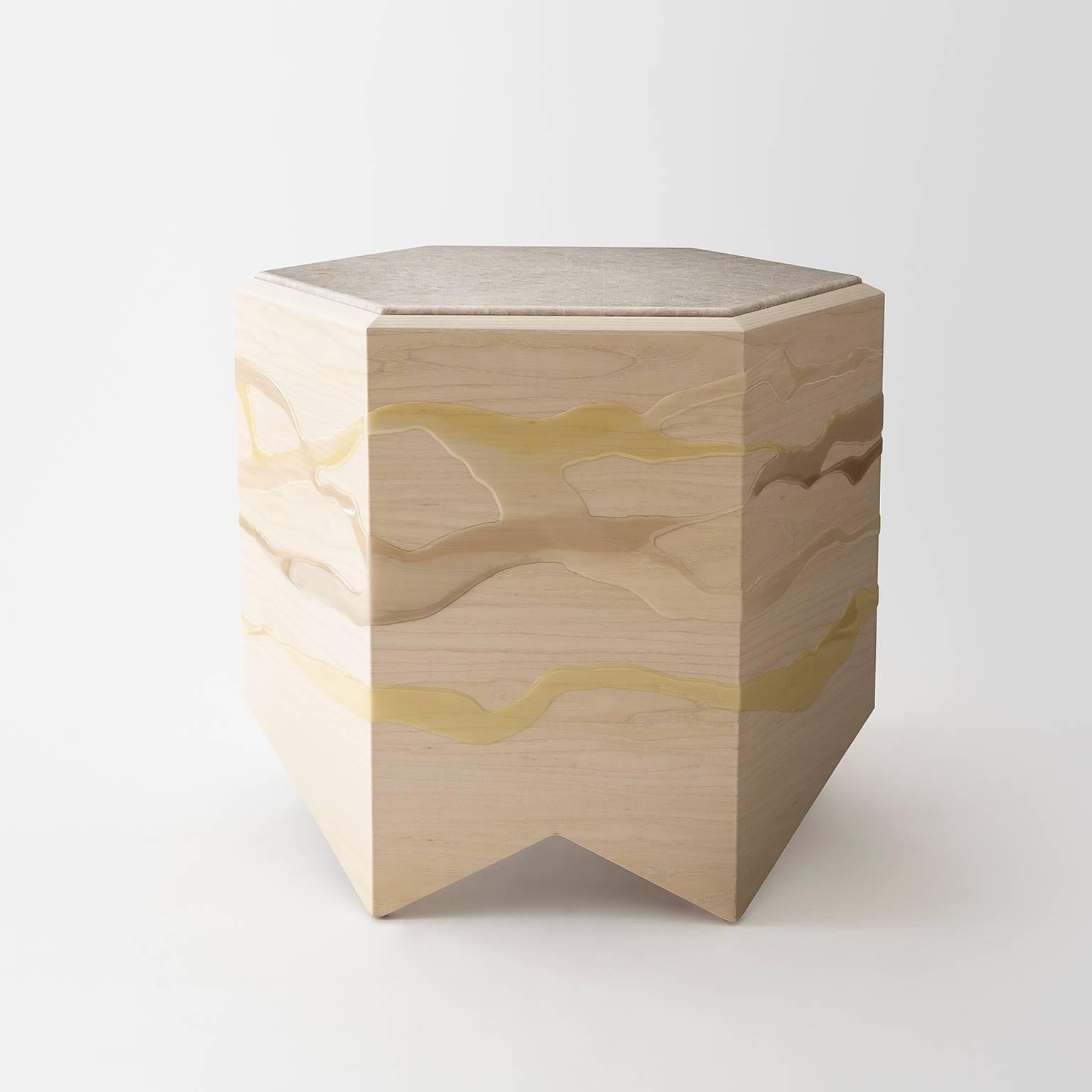 The drip-fold side table by Noble Goods is constructed of a single sheet of ash plywood that has been hand-dripped with liquid resin, then bent into a hexagonal shape. Each table is finished with a custom stone top.

Each drip-fold table is made