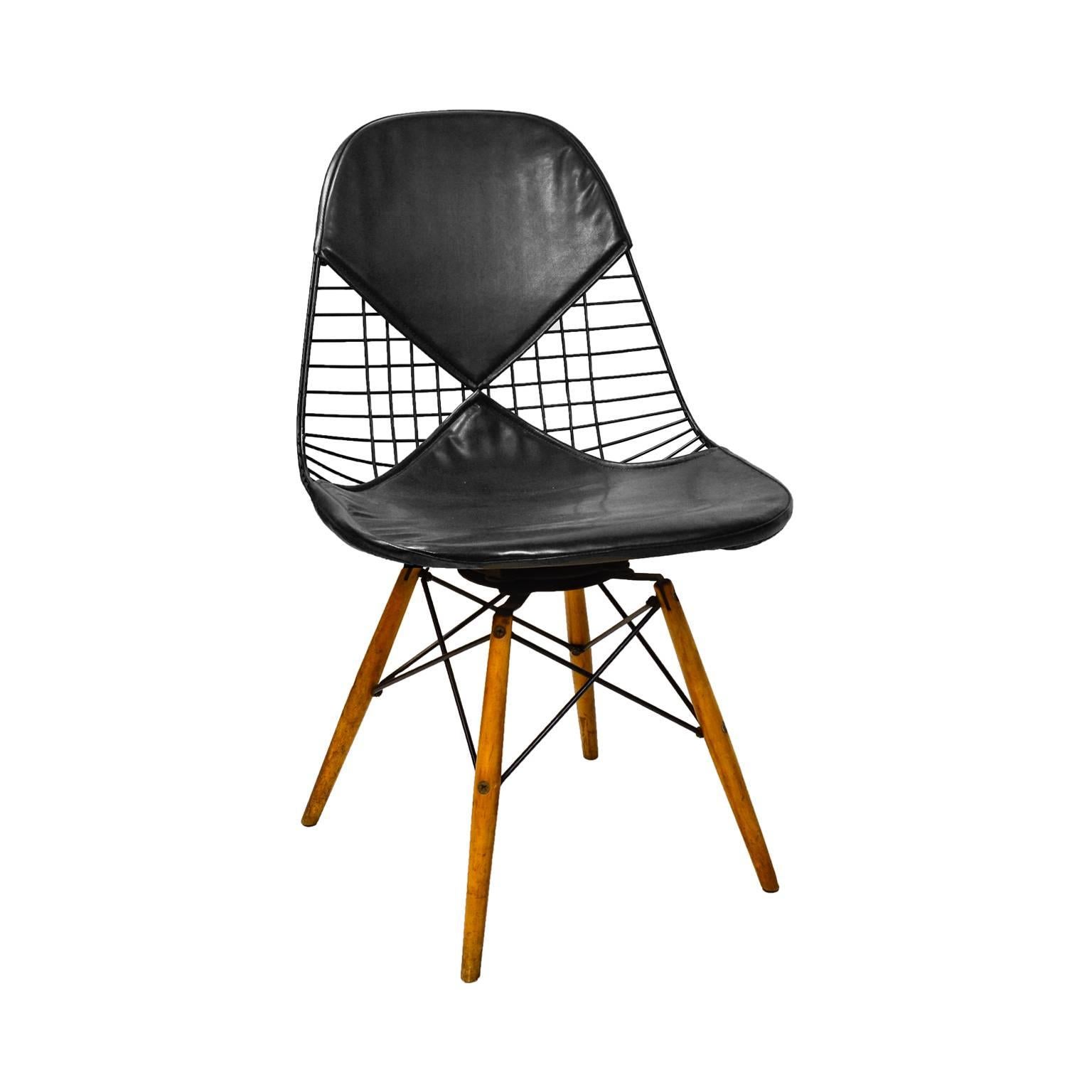 Charles and Ray Eames for Herman Miller DKW swivel side chair with bikini cover and walnut dowel legs, 1950.