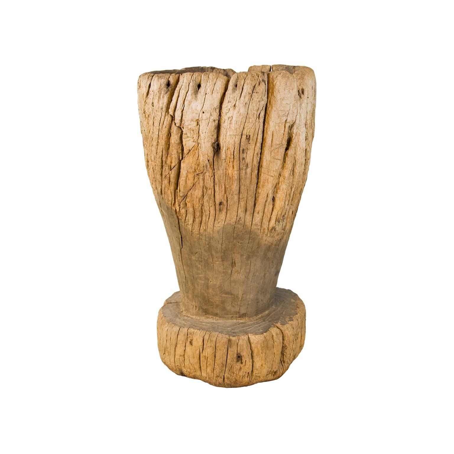 Large mortar and pestle from late 19th to early 20th century, carved from single piece of wood. This item was used to mill grain and wheat. 

Measures: Mortar height 33in, diameter 19.5in
Mortar bowl depth 12in
Pestle height 31in.