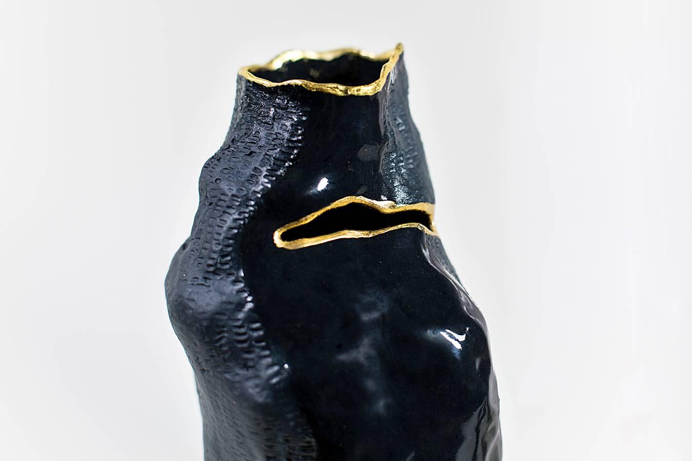 This handbuilt one-of-a-kind ceramic vase is hand built with stained English Porcelain and a delicate 23-karat gold leaf detail is applied with ormolu technique. 
This piece features a combination of unglazed and glazed (clear) finishes, textured