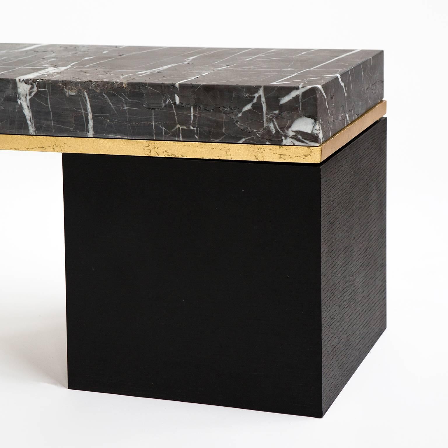 Minimalist and elegant, this Found Bench No.1 features a naturally broken slab of grey marble that was hand-picked at a family-owned quarry in Turkey. The base consists of gold-leaf covered steel, and a dyed solid white oak. 
Customization