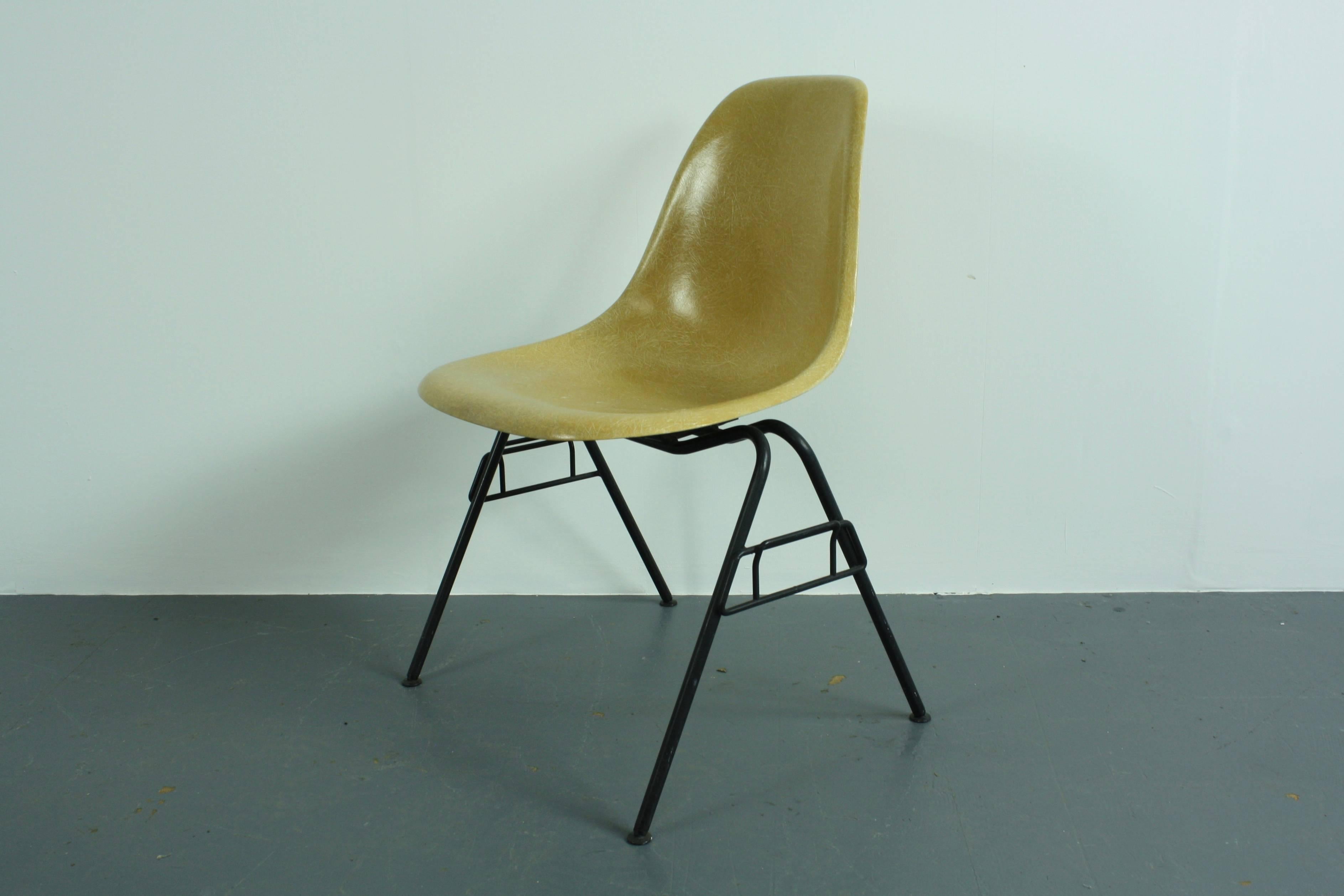 DSS chair designed by Charles Eames and made by Herman Miller in the late 1950s-early 1960s. Original fiberglass weaves shell in light ochre, with an original stacking base. Original Herman Miller stamp on underside of shell.

The contemporary