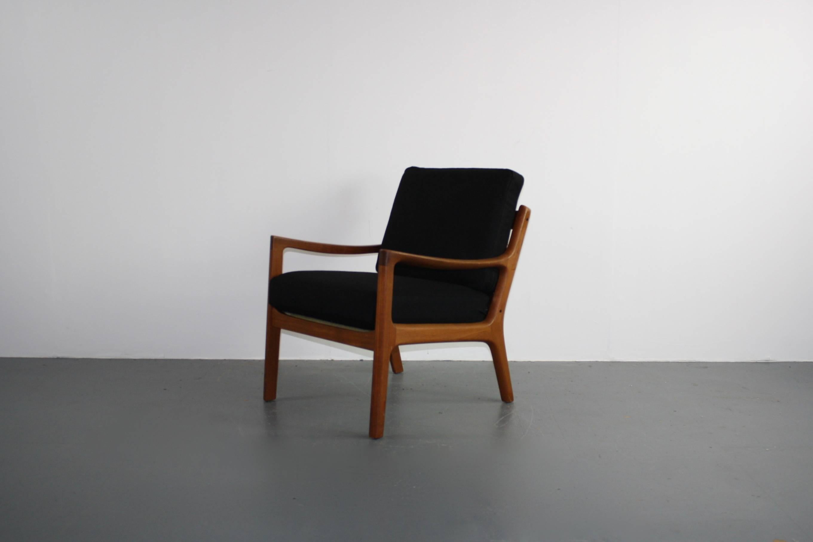 1960s teak lounge chair designed by Ole Wanscher for Cado (France & Son). Solid teak, with beautifully designed curved arms. With 2 thick spring-loaded cushions, making the chair supremely comfortable, which have been newly upholstered in Abraham
