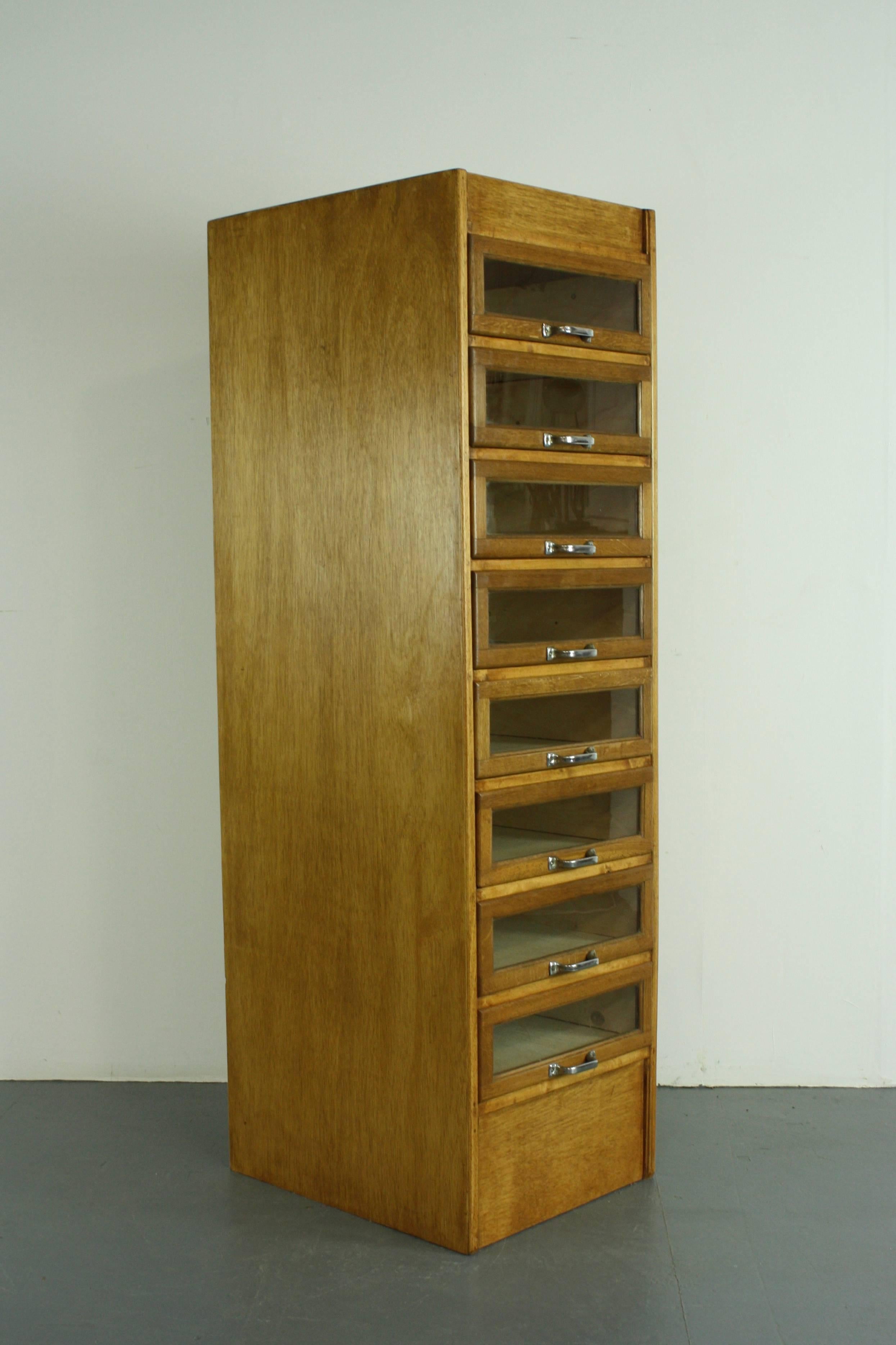 Eight-drawer single column haberdashery shop cabinet. 

It has eight glass fronted drawers, all with metal D handles.

Approximate dimensions:

Height: 159.5cm

Width: 46.5cm

Depth: 56.5cm

Drawers: 41cm x 44.5cm x 12.5cm.

Overall,
