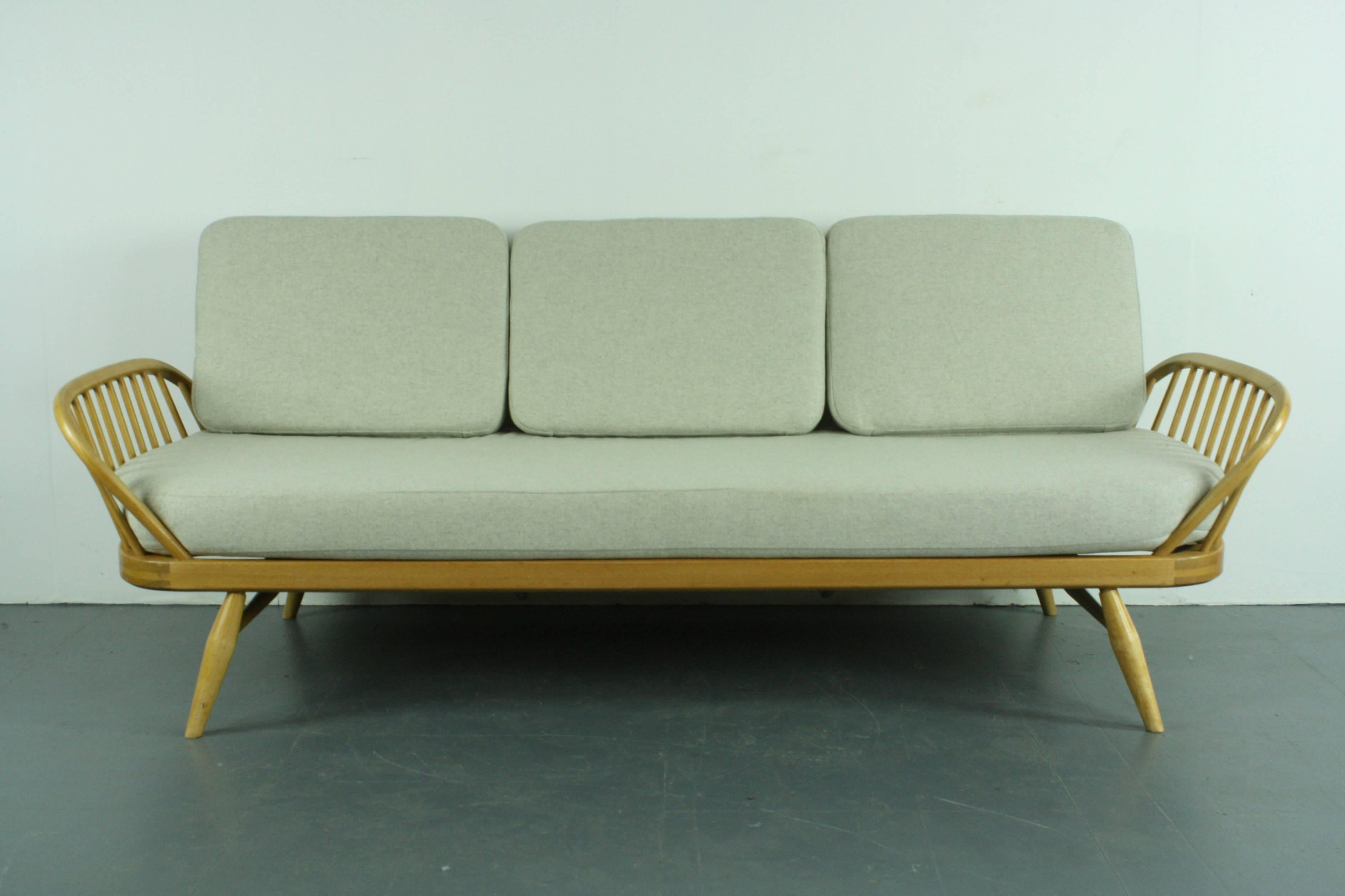 Refurbished vintage Ercol 355 Studio couch or sofa bed.

Inspired by Scandinavian design, the Studio Couch was designed by Lucian Ercolani in 1958 and manufactured by Ercol in the 1960s-1970s.

This is the much sought after blonde (beech)