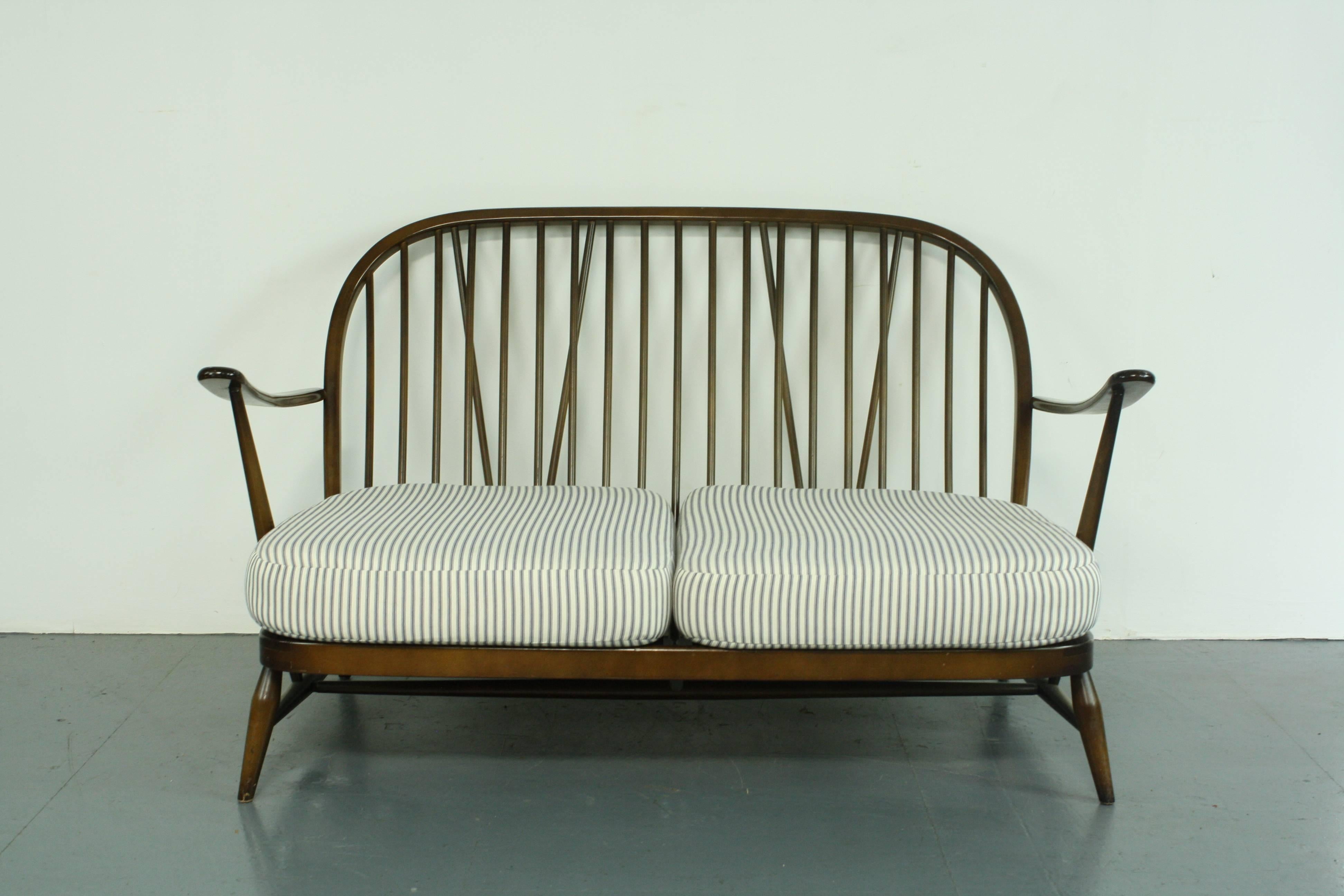 Refurbished dark elm Ercol Windsor two-Seat sofa.

Newly upholstered in lovely French ticking. 

This piece is in good vintage condition. The frame is solid and sturdy. There are a few scuffs, scratches and marks commensurate with age but