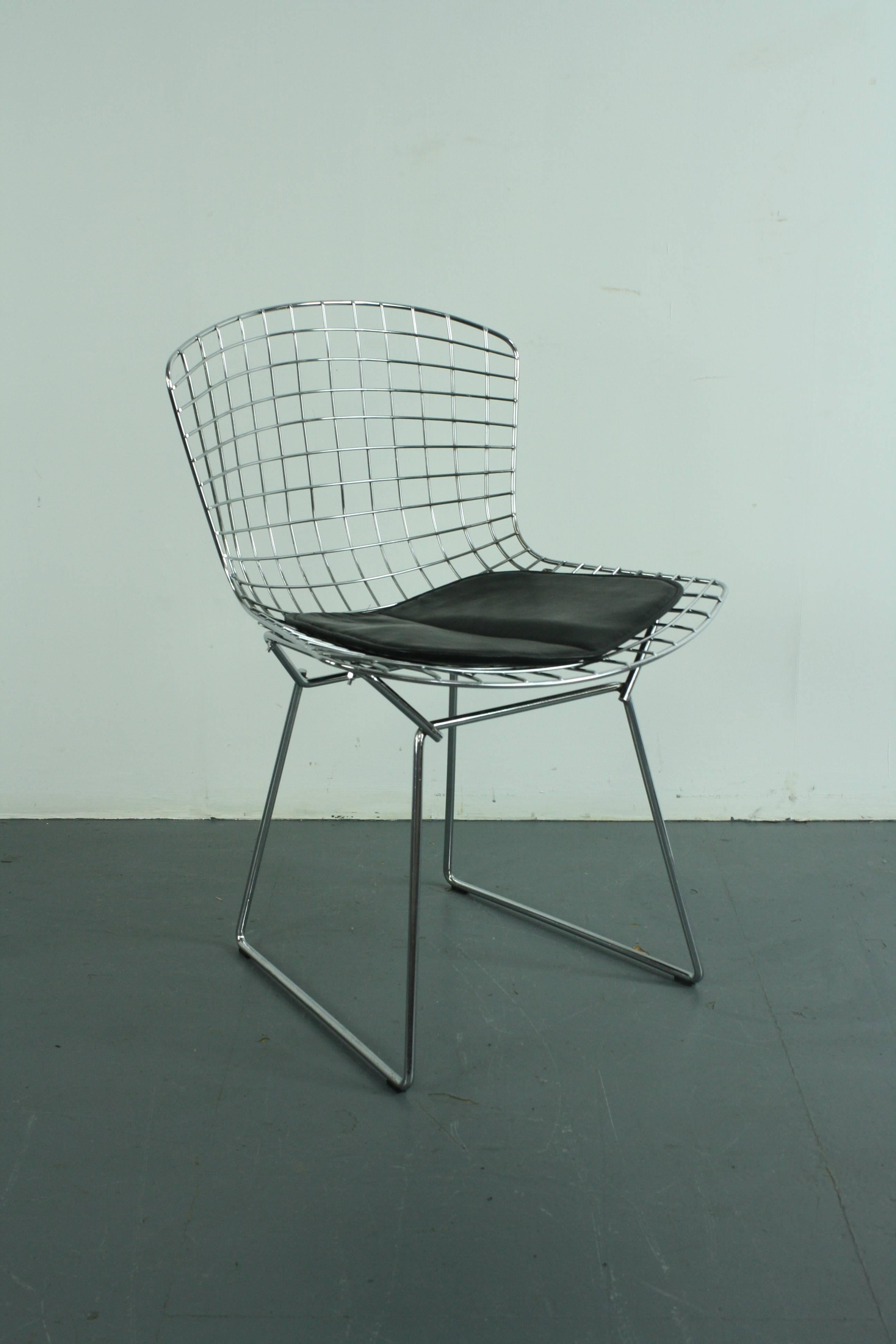 Original Bertoia side chair designed by Harry Bertoia for Knoll in the 1950s with black seat pad. 

As Knoll say: 