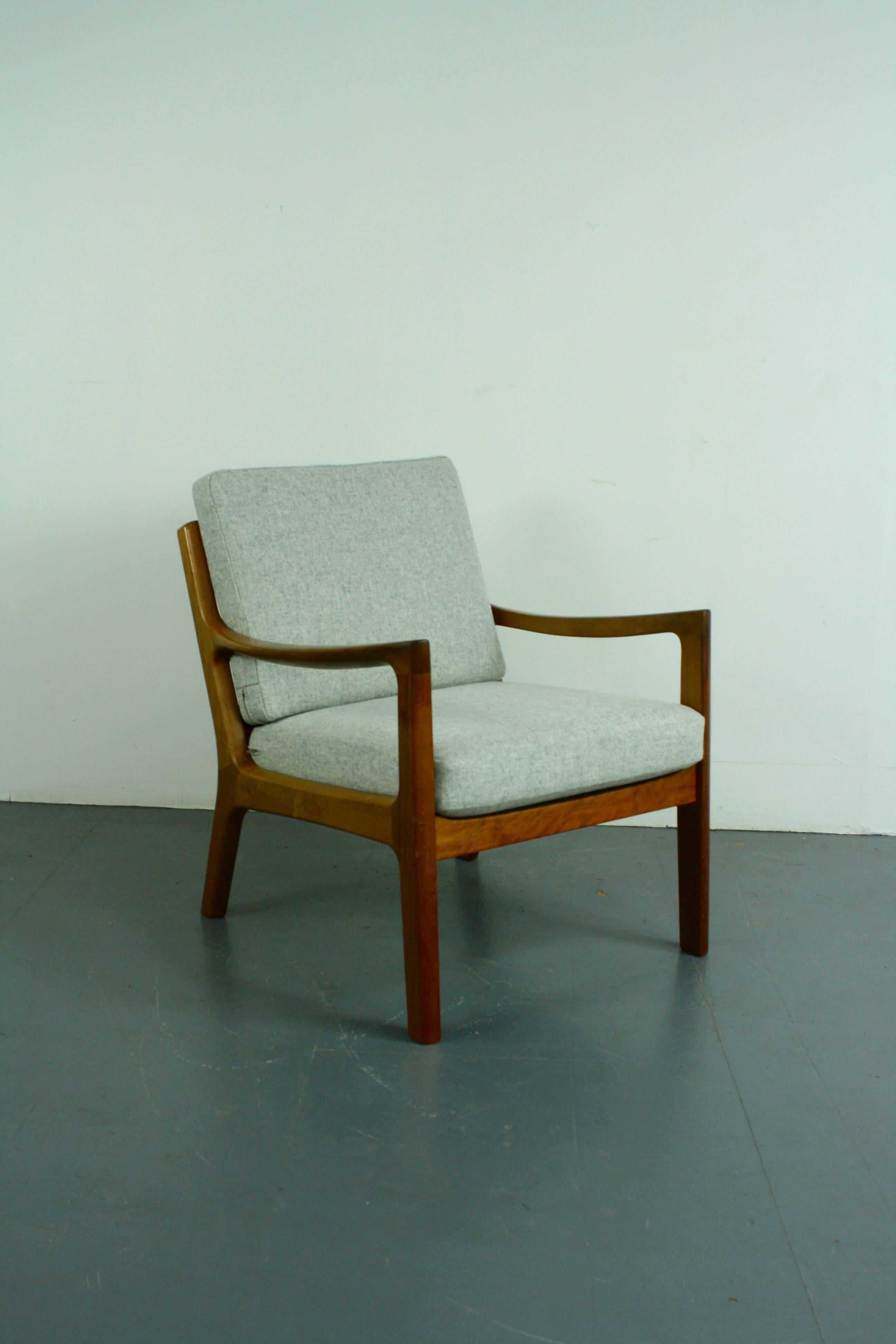 1960s teak lounge chair designed by Ole Wanscher for Peter Jeppeson. Solid teak, with beautifully designed curved arms. With two thick spring-loaded cushions, making the chair supremely comfortable, which have been newly upholstered in beautiful