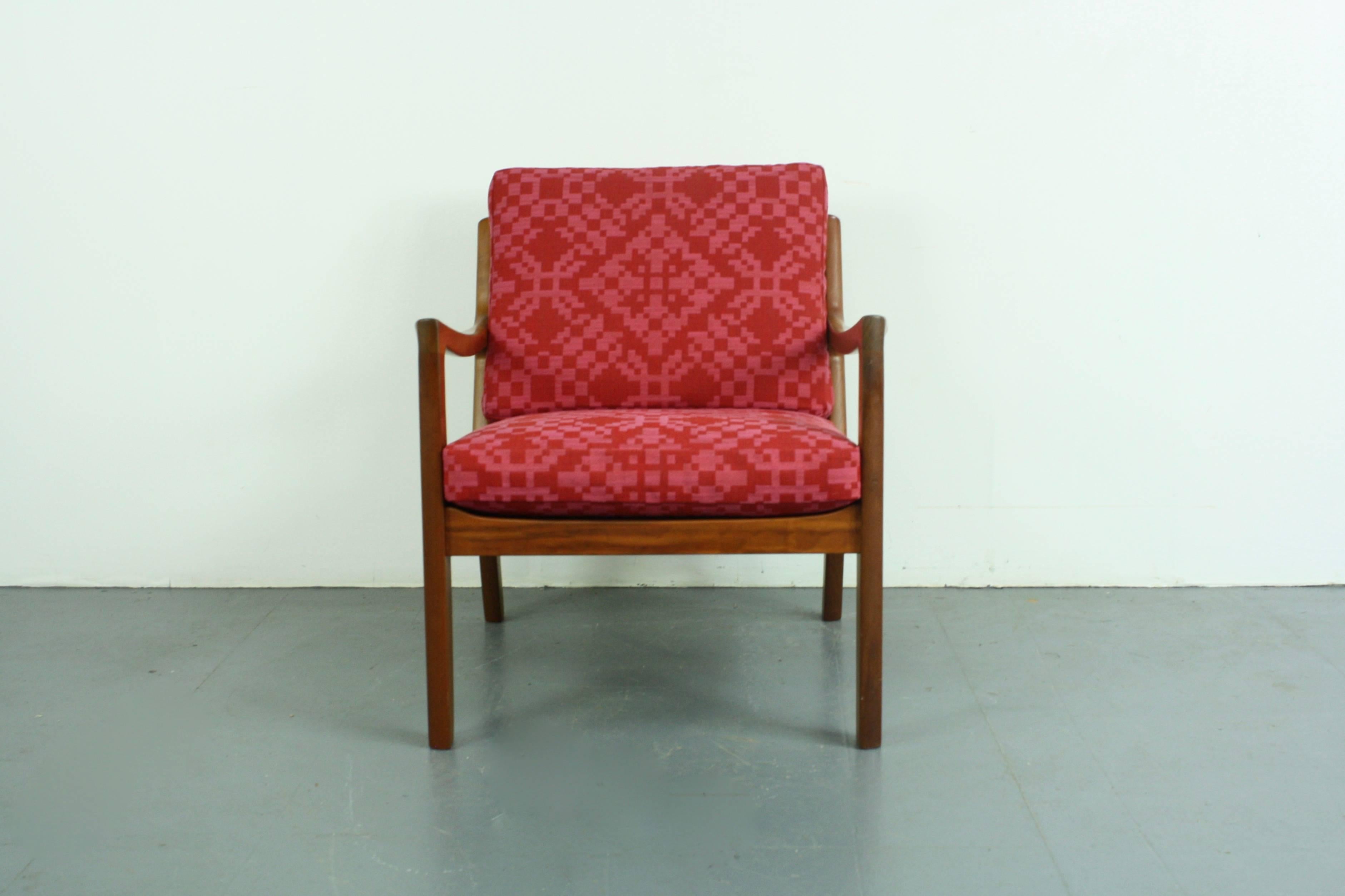 1960s teak lounge chair designed by Ole Wanscher for Cado (France & Son). Solid teak, with beautifully designed curved arms. With 2 thick spring-loaded cushions, making the chair supremely comfortable, which have been newly upholstered in Abraham