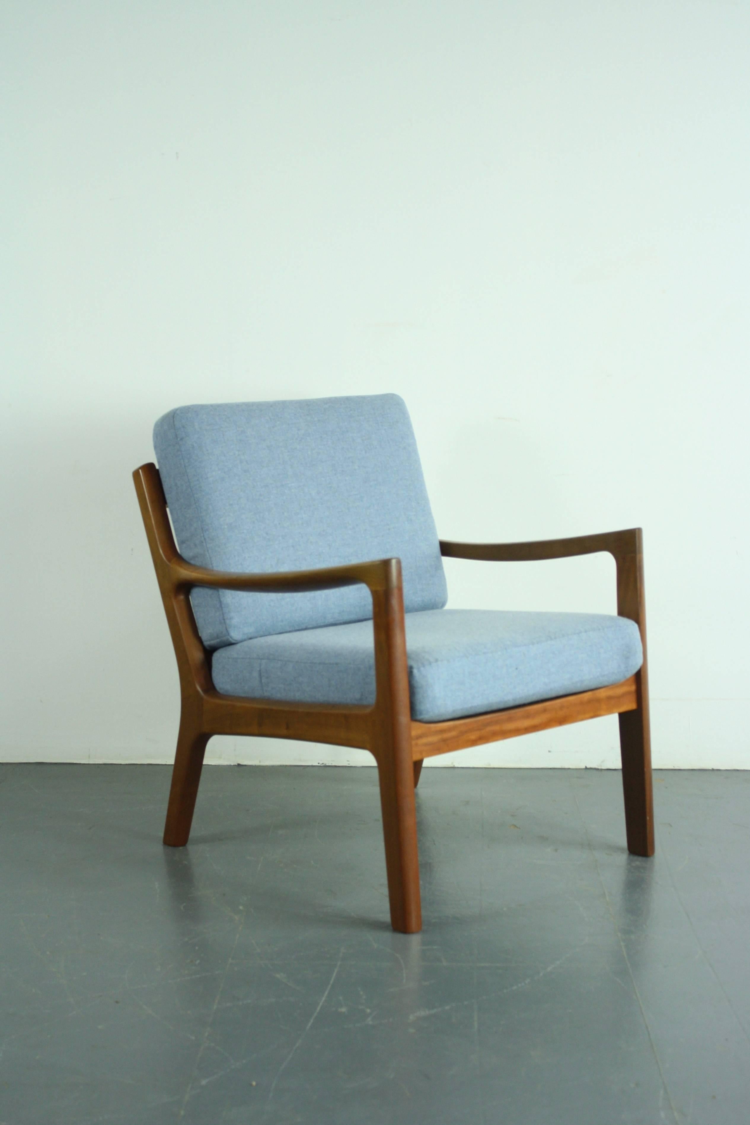 1960s teak lounge chair designed by Ole Wanscher for Peter Jeppeson. Solid teak, with beautifully designed curved arms. With 2 thick spring-loaded cushions, making the chair supremely comfortable, which have been newly upholstered in a beautiful