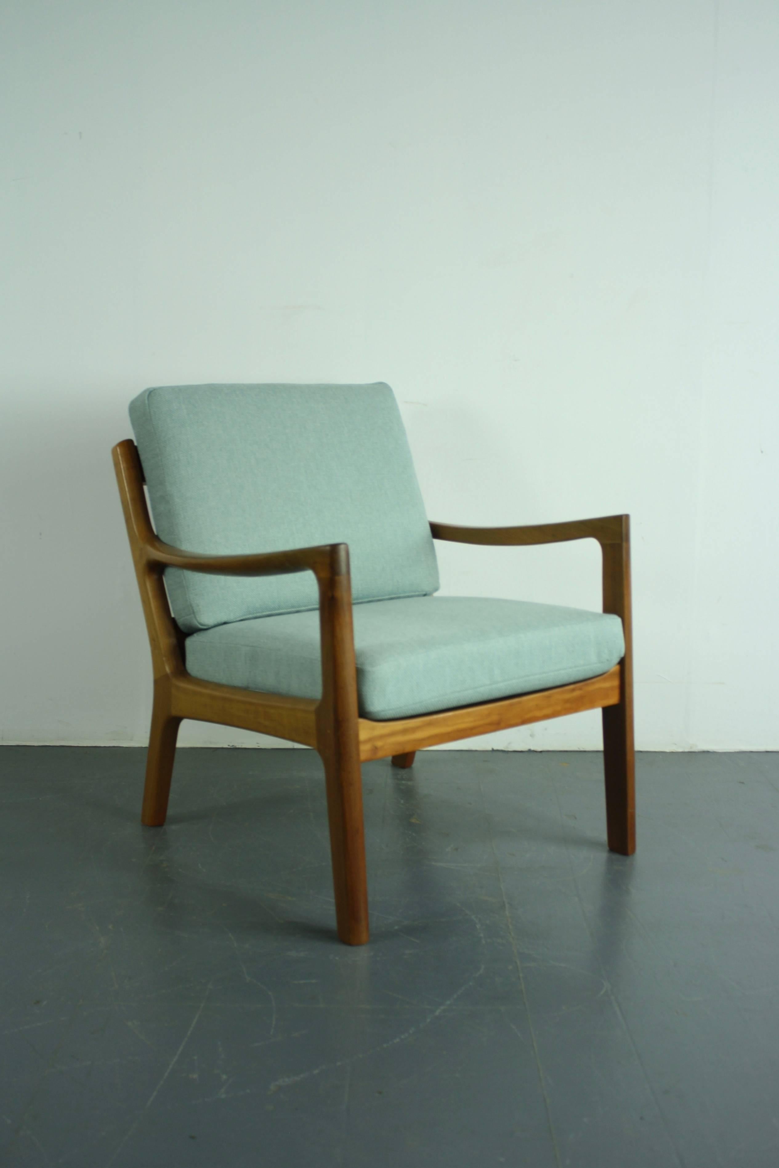 1960s teak lounge chair designed by Ole Wanscher for Peter Jeppeson. Solid teak, with beautifully designed curved arms. With two thick spring-loaded cushions, making the chair supremely comfortable, which have been newly upholstered in a beautiful