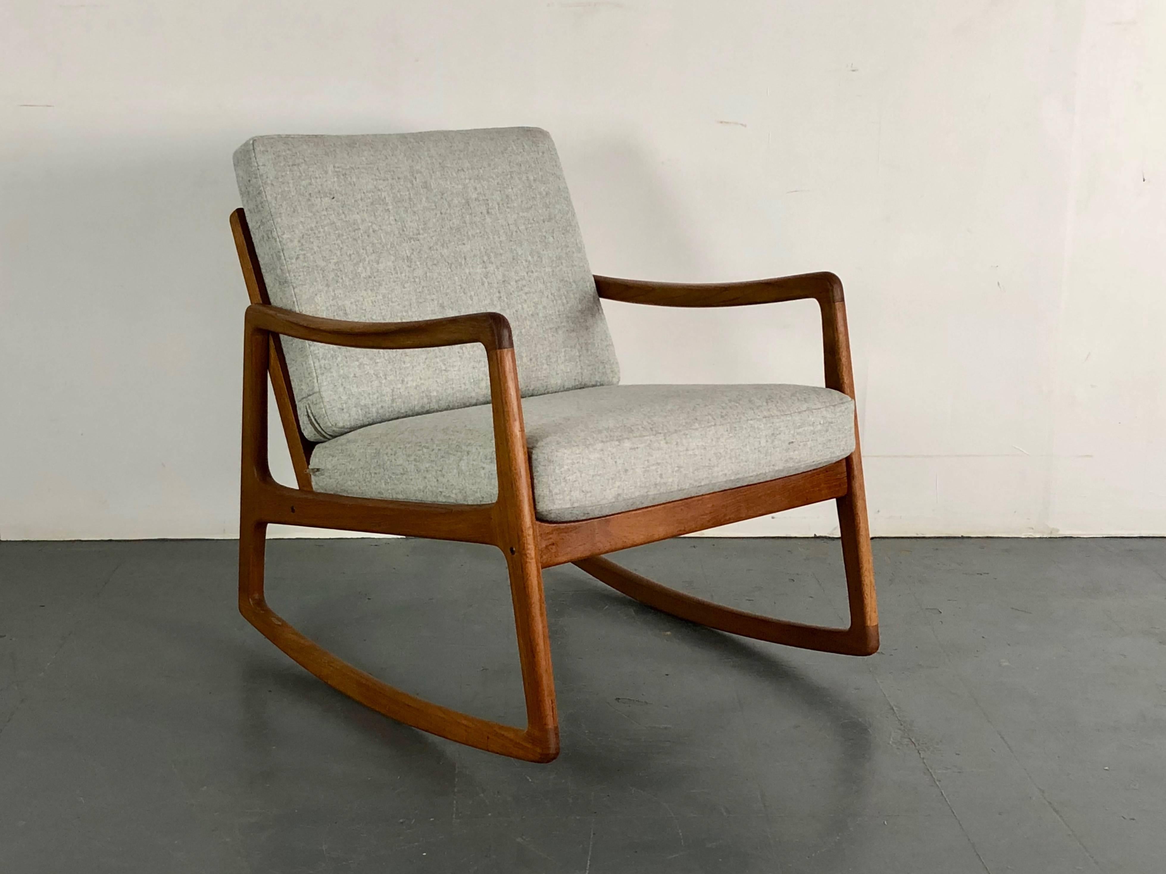 1950s solid teak rocking chair designed by Ole Wanscher for France & Son, Denmark.

With newly upholstered cushions in gorgeous grey Abraham Moon pure new wool.

Approximate dimensions:

Width: 61cm

Height: 76cm

Depth: 80cm

Seat