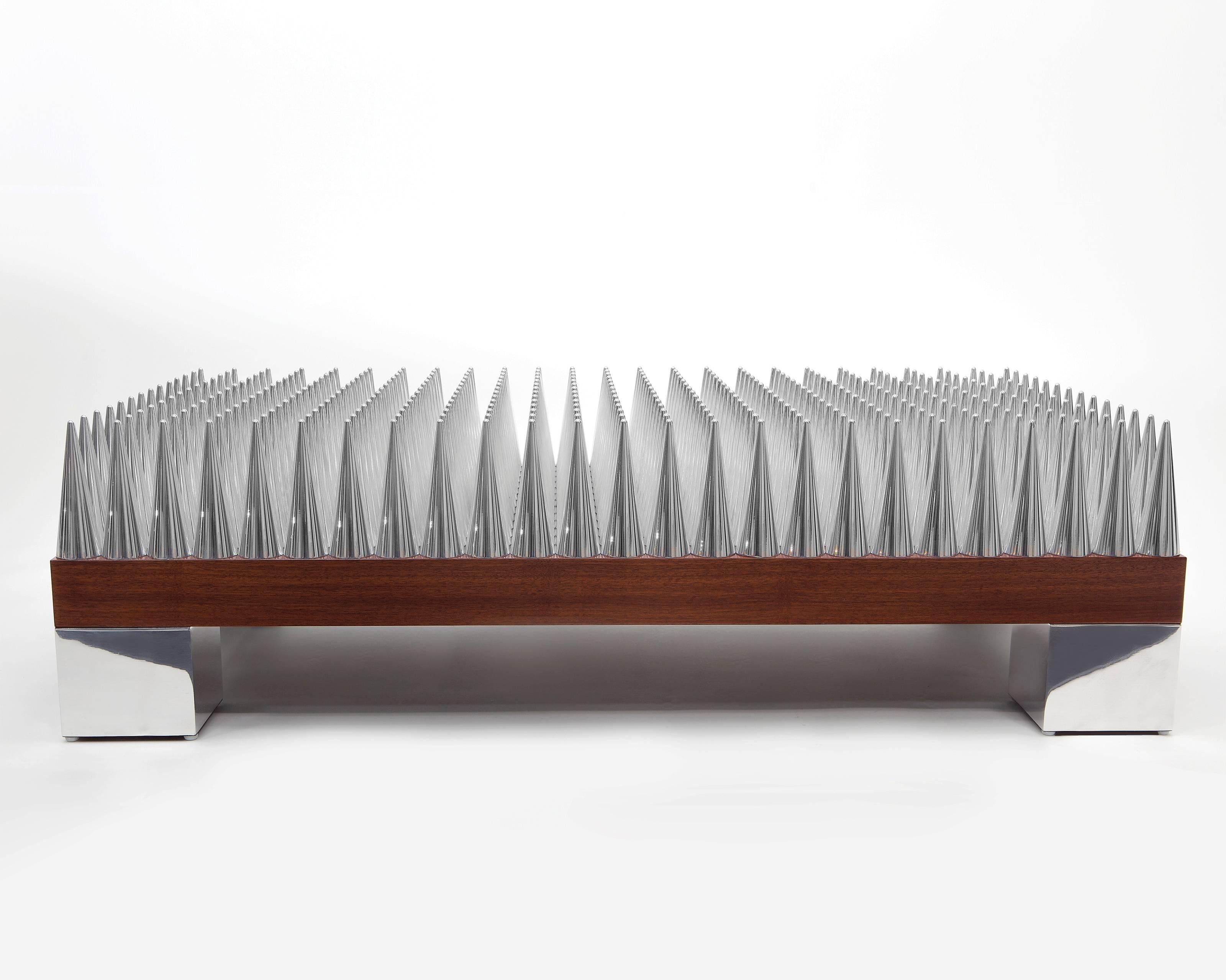 Light, symmetry, and sculpture come together to create the perfect mise en scene for your more daring side. The spike coffee table is the tour du force centerpiece for those who dabble in an unconventional way of life. Solid walnut and billet