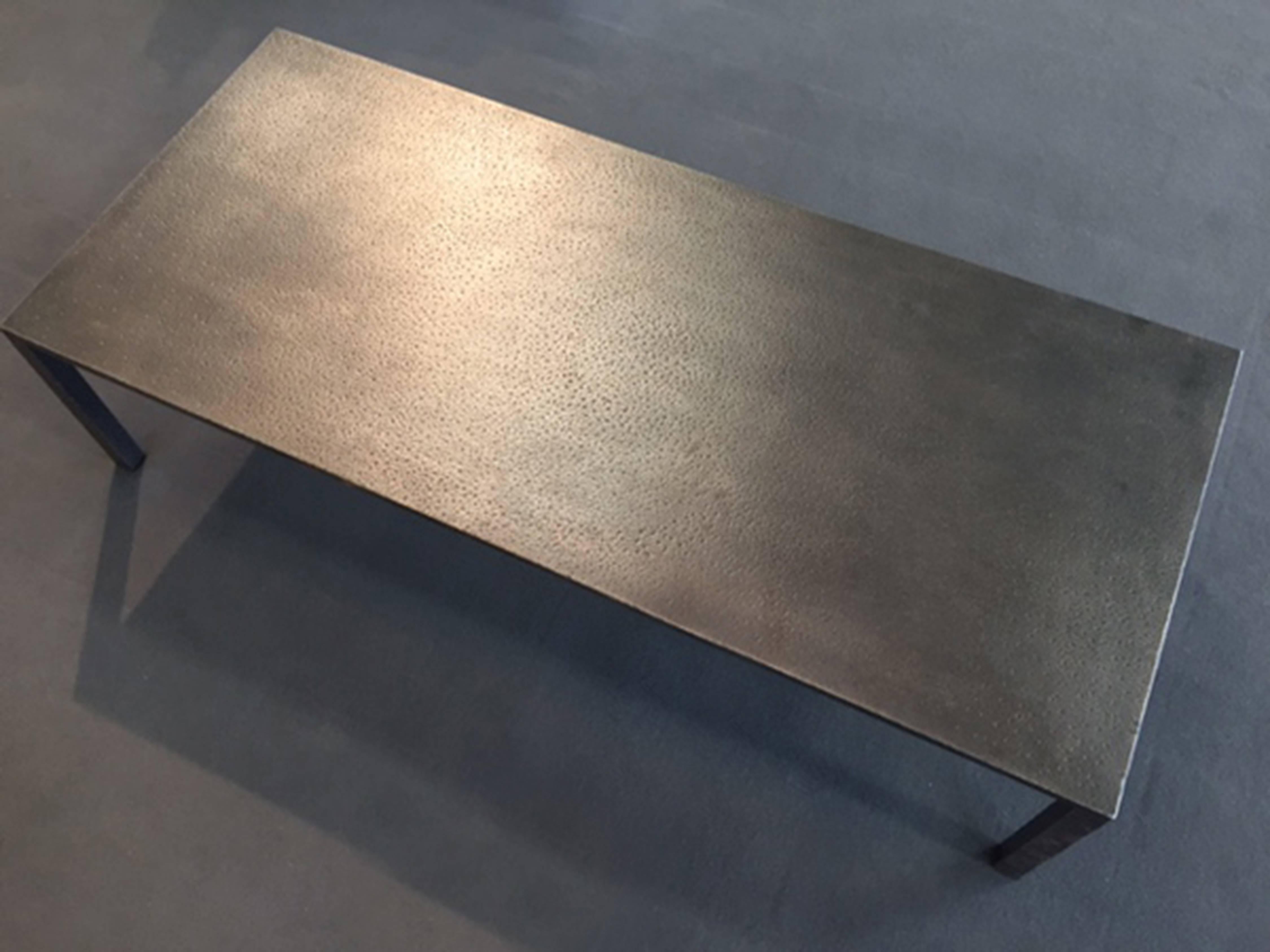 Low steel coffee table, hand-hammered textured. This table combines minimalism with a rustic aesthetic, giving this table a clean and bold presence.