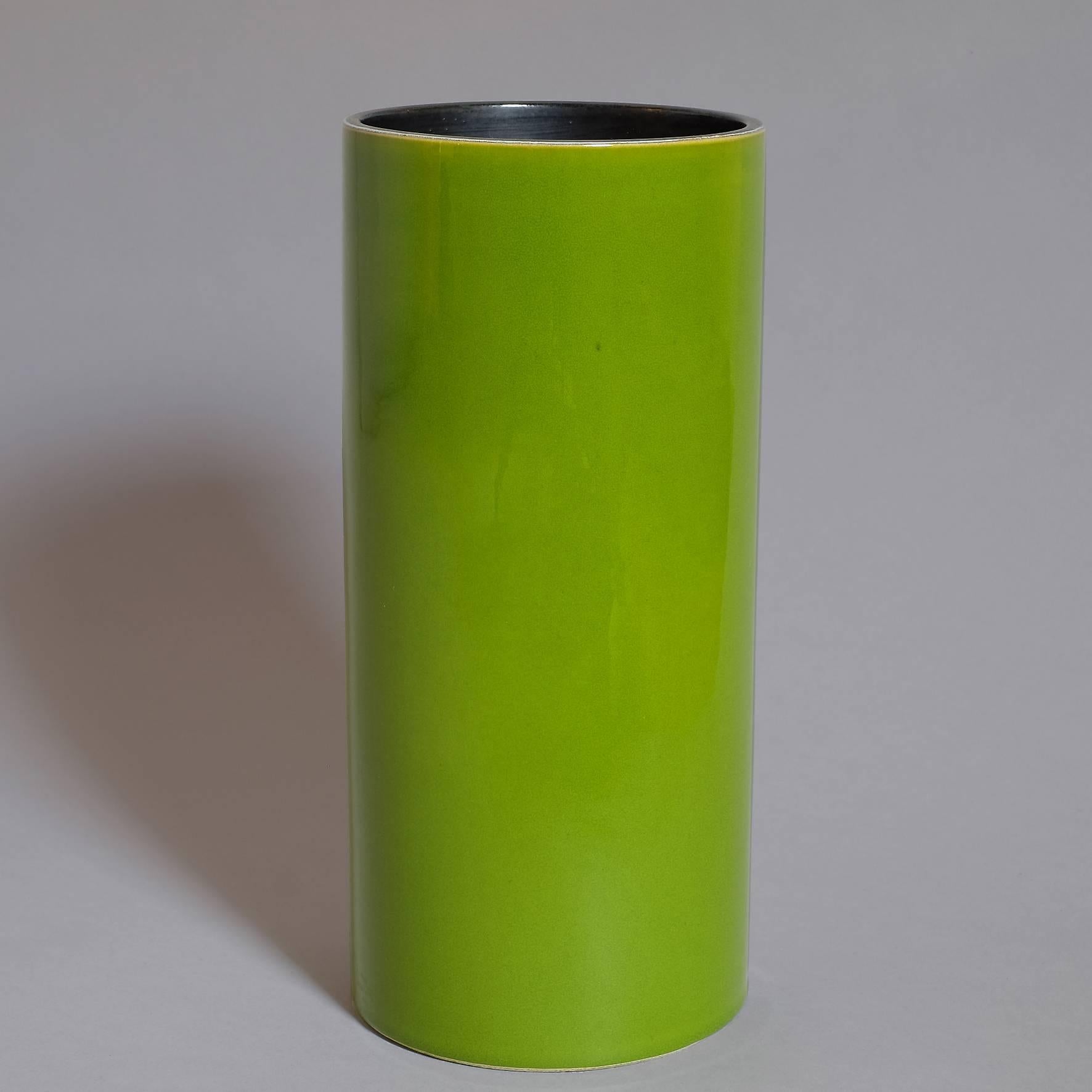 A green glazed ceramic cylindrical vase with a black covered interior.
Signed underneath "Jouve" and artist's cypher "Alpha".