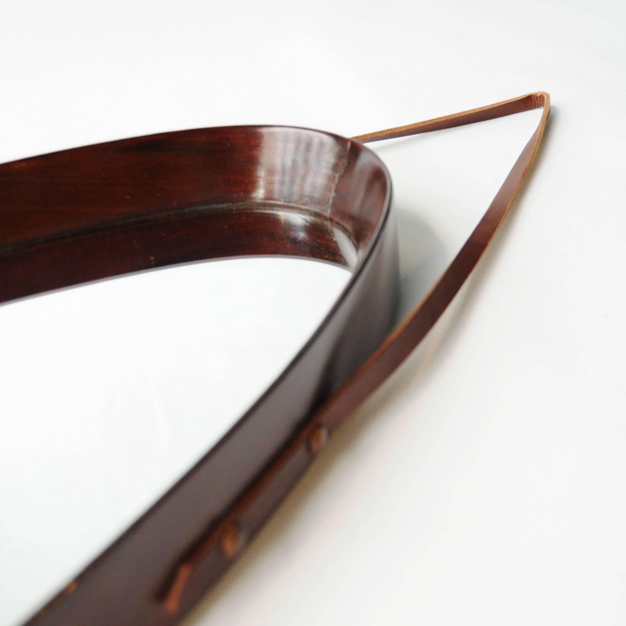 Original French mirror with a frame made in walnut wood and leather girth.