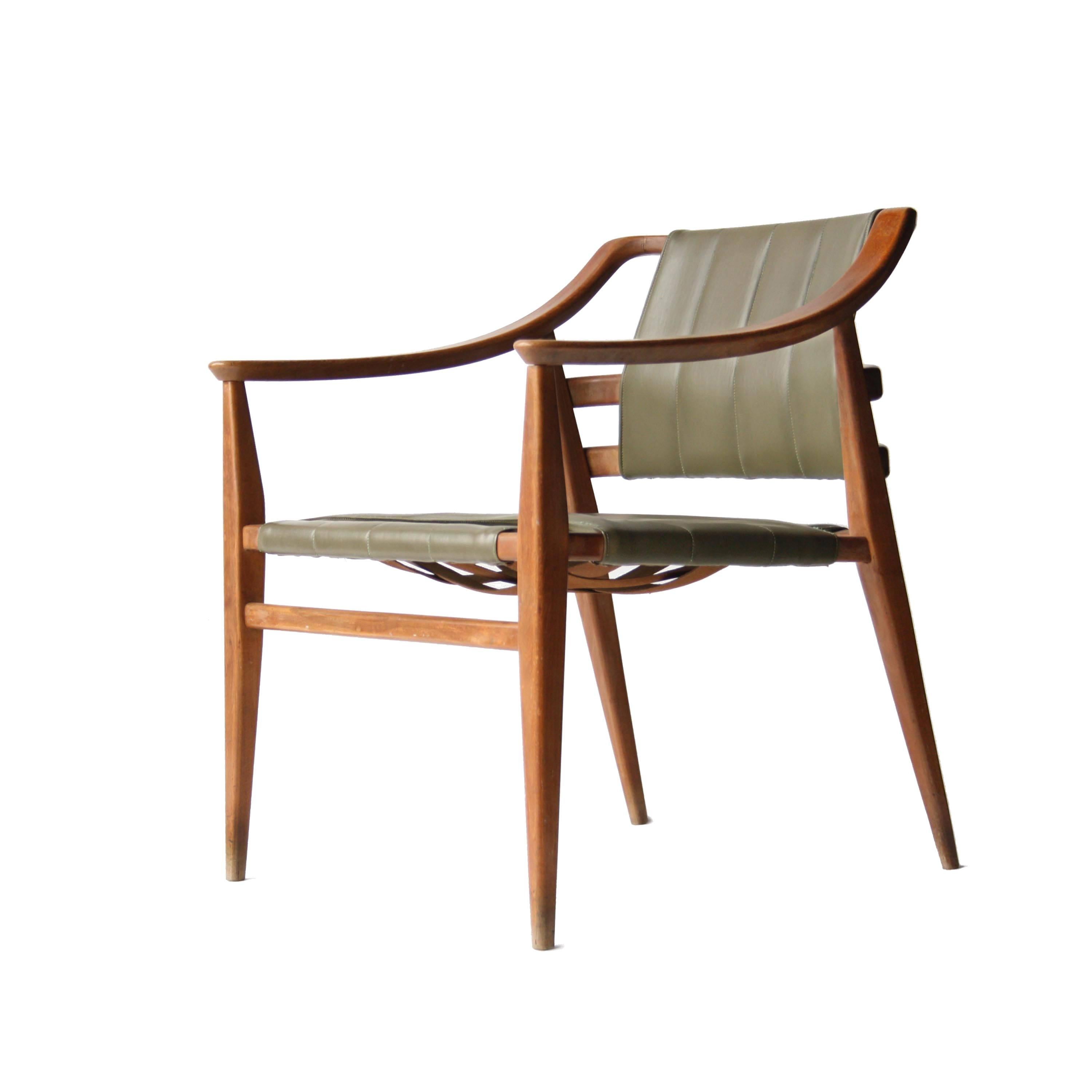Armchair and footstool made of solid teak with upholstered in polyskin green.