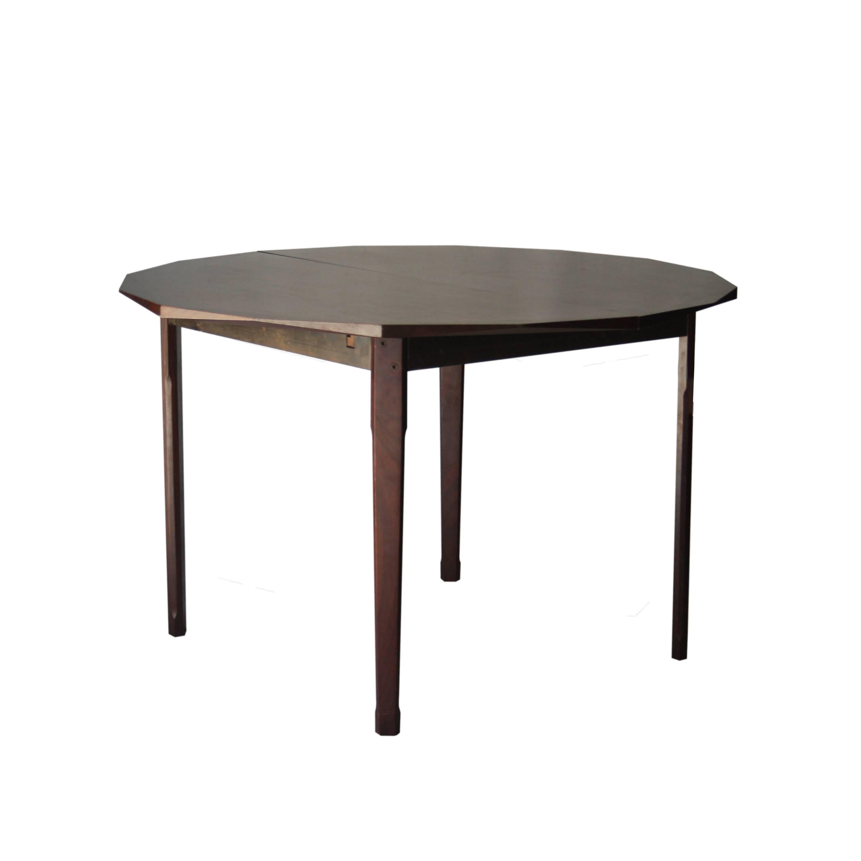 Extensible dining table. Geometric shaped top made of rosewood. Two extensible within.