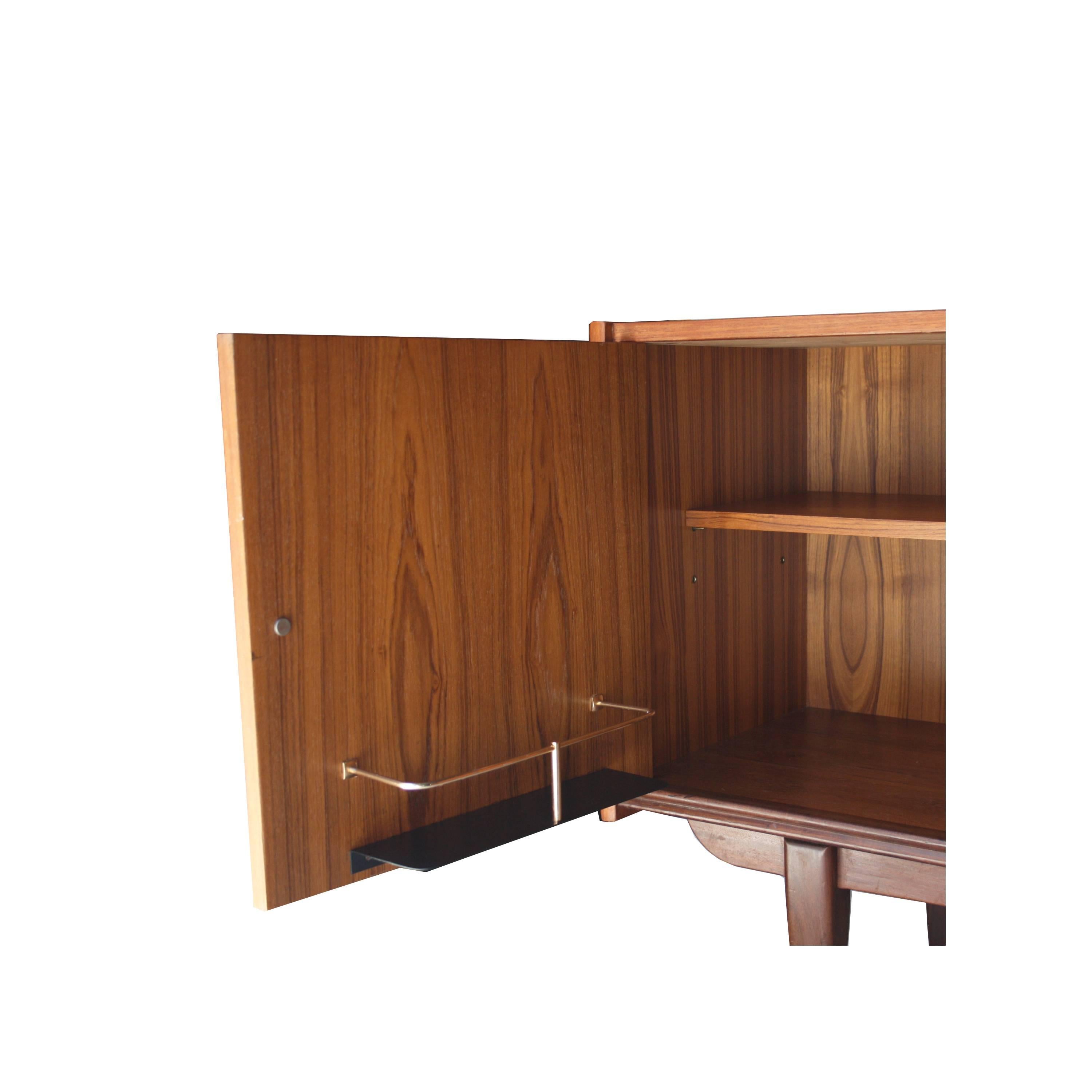Sideboard with wooden solid structure covered in walnut veneer. With four drawers, three doors. Storage module and interior wine rack.
