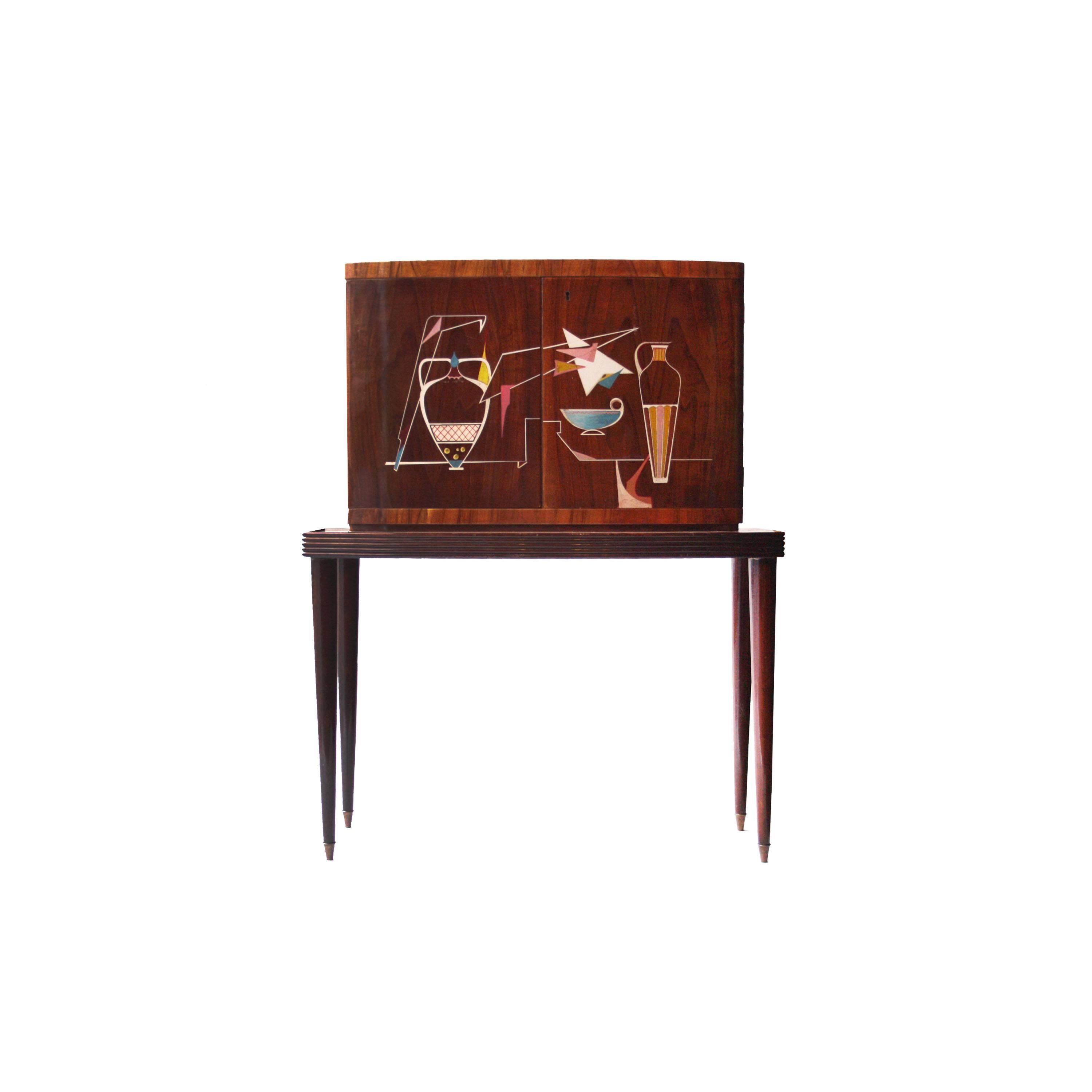 Bar cabinet composed of two bodies with solid wood structure covered in rosewood and lemon tree. Interior covered in mirrors, with three drawers, metal side racks and backlit on the back. Conical legs finished in brass detail.