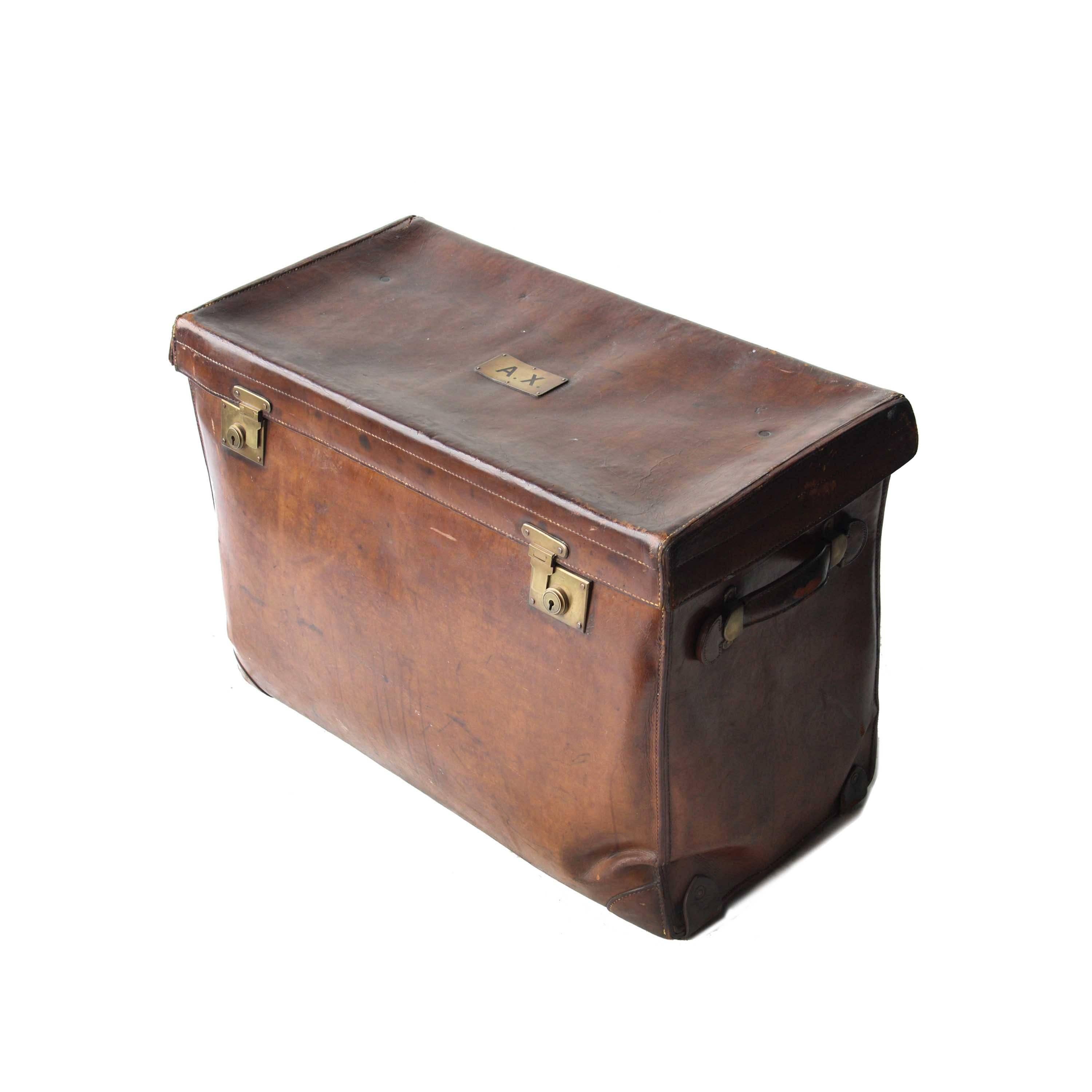 Cargo chest made of leather with brass plate with initials engraved on top lid, origin seal inside.