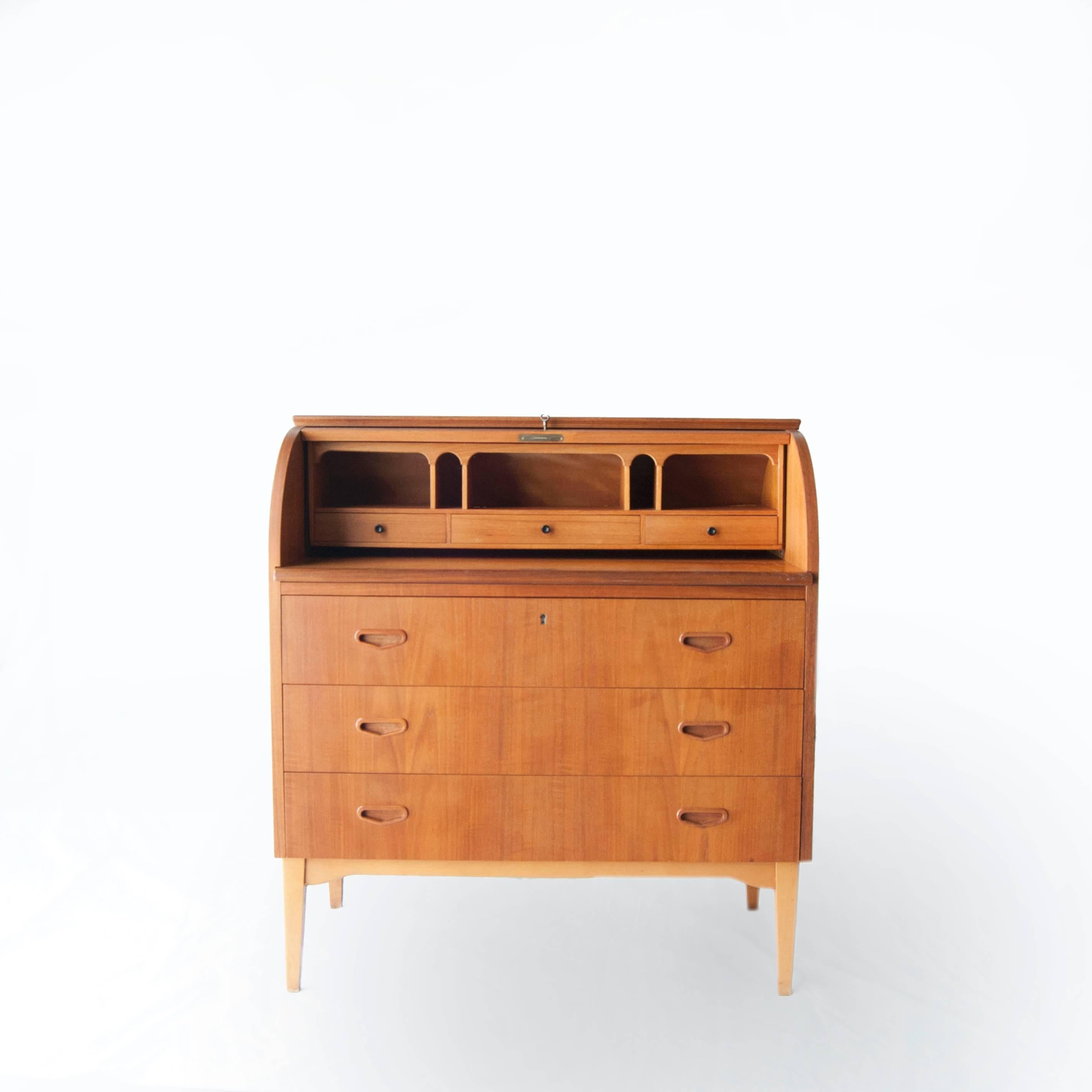 Bureau made in teakwood with three drawers, extensible writing desk and a secreter close by a folding door.