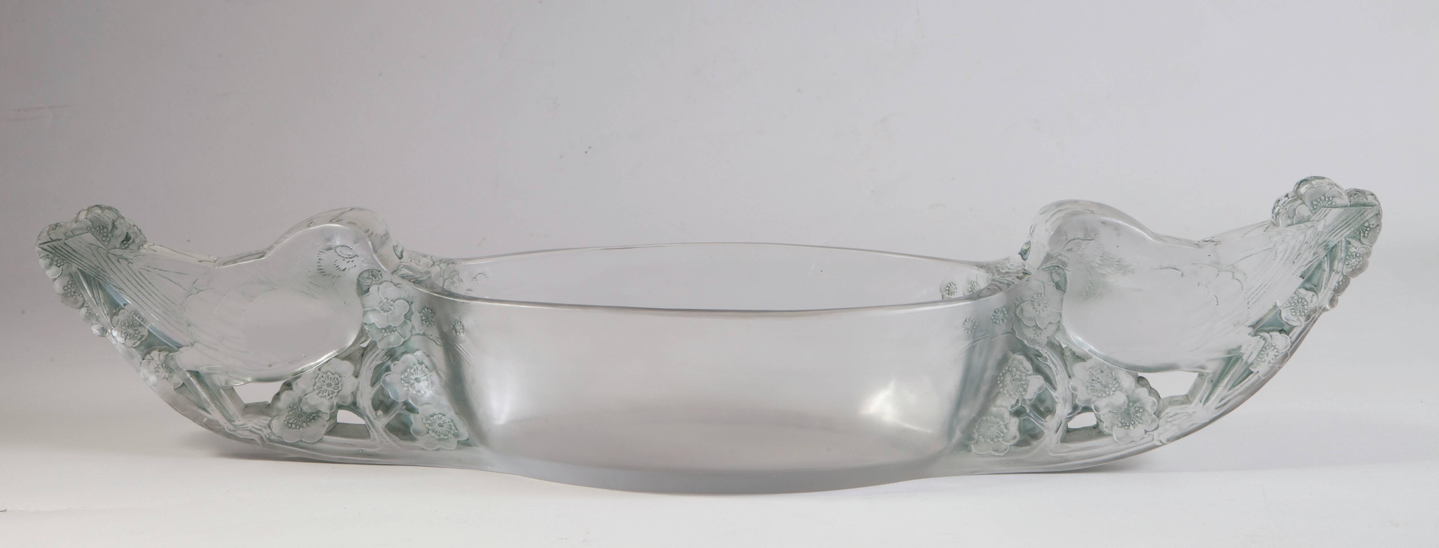 Rene Lalique table centre mesanges: 53.5 cm long 
heavily molded frosted glass bowl form with a facing bird resting on foliage on each end centre. 
Frosted bowl form flanked at each end by an inward facing patinated bird on branch thickly and