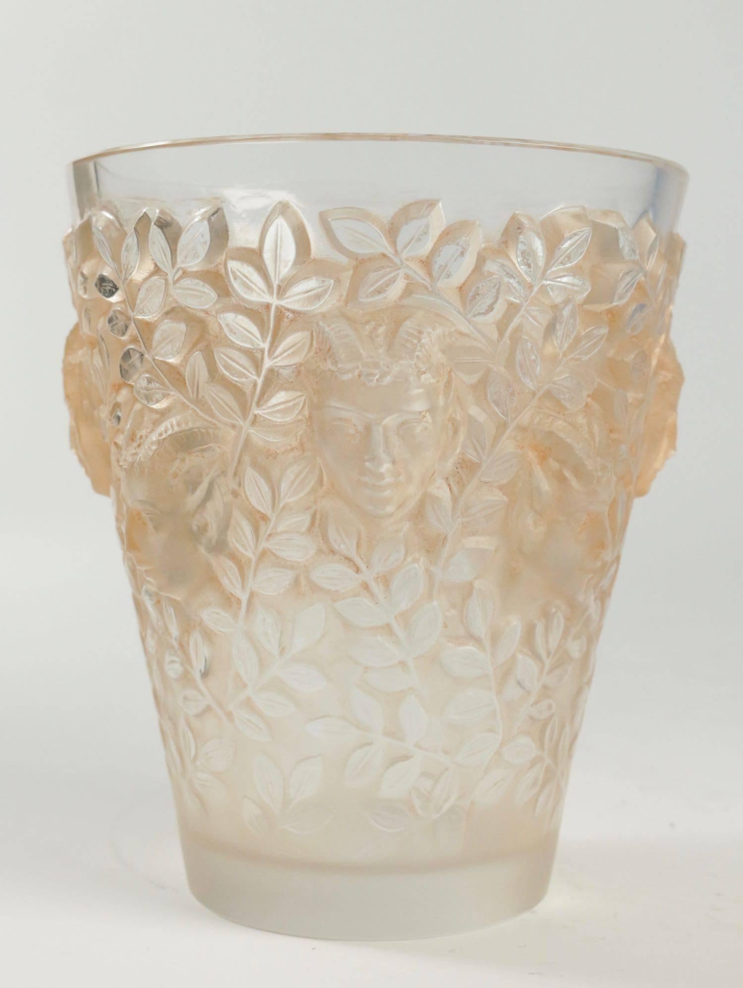 Lalique Silenes vase of tapered form, moulded in high relief to the exterior with a continuous frieze of leaves and faunes heads, highlighted with sepia stain.
Model introduced in 1938,
Base stamped with stencil mark 'R.Lalique, France'.
   