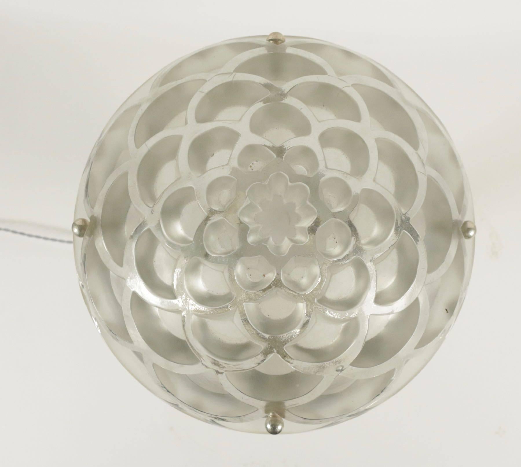 Rinceaux plafonnier
Designed 1926, clear and frosted with suspension cords and moulded glass ceiling rose wheel-engraved R. LALIQUE FRANCE 38 cm. diameter

Glass cup a satiny moulded-pressed glass bowl model created in 1926. Signed 