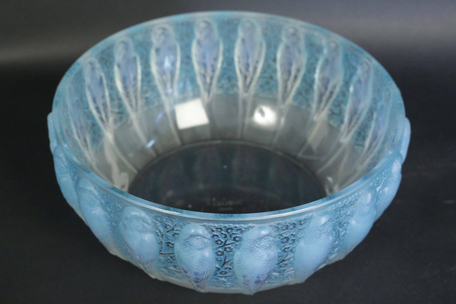 Repeating parrots against a floral background decorated R. Lalique bowl. Model: 419, circa 1931.
Measures: 24 cm wide by 11 cm tall.
