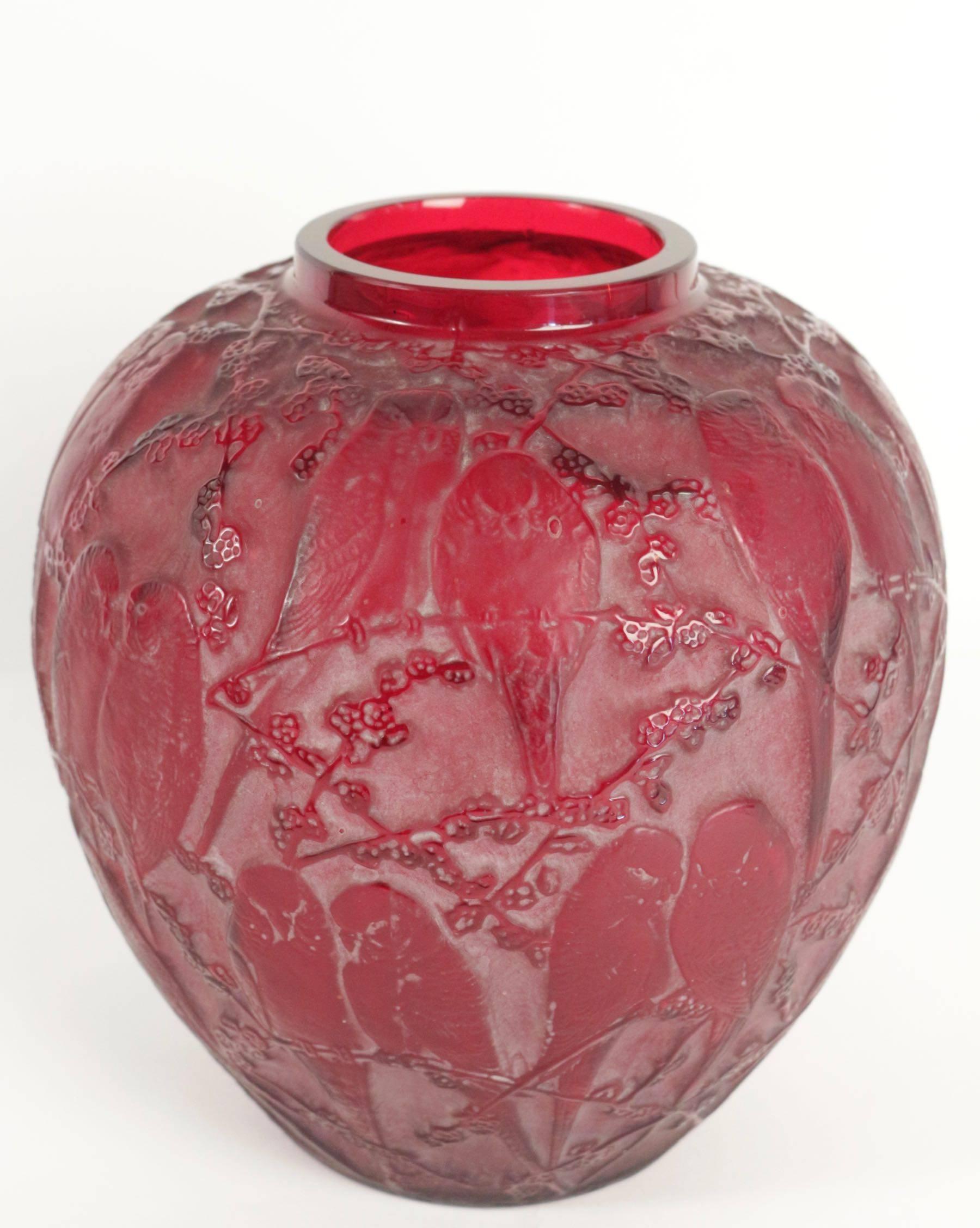 Rene Lalique (1860-1945).
Red glass decorated all-over with a design of pairs of small birds perched amongst foliage.
Likelythe most beautiful example that reached the market in decades!

Vase 