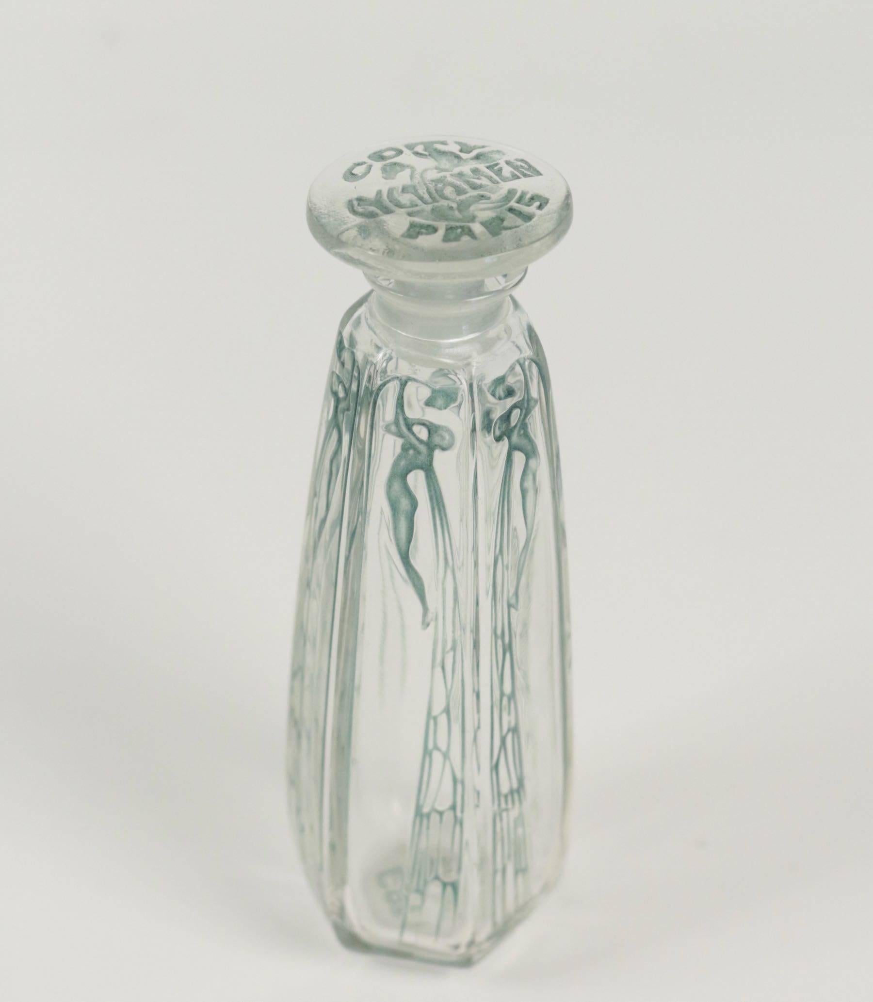 13.5 cm tall.
 Clear glass with a patinated design of frosted winged women R. Lalique Perfume Bottle signed R. Lalique in the mold on a lower receding edge and Coty Paris on the underside.
Rene Lalique Coty.

Cyclamen Flacon en verre-soufflé