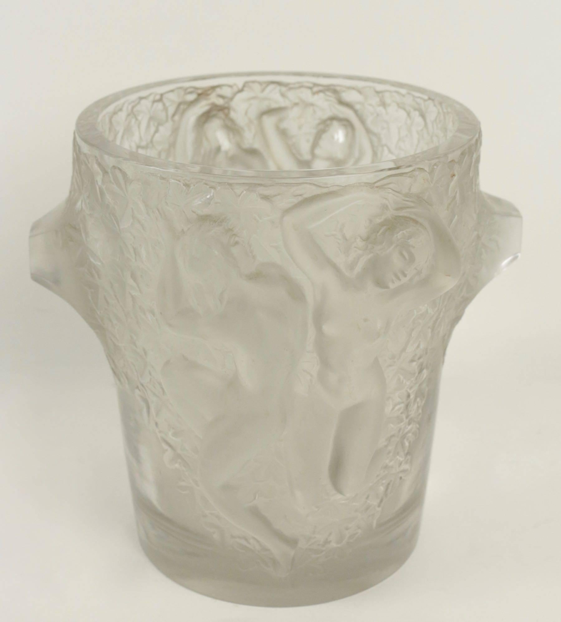 Lalique ice bucket depicting dancing female figures in high relief, circa 1938 design no. 11951. This piece is a perfect example of Lalique's Classic quest for elegant simplicity.
Signed RLalique France on bottom. Measures: 9 1/8