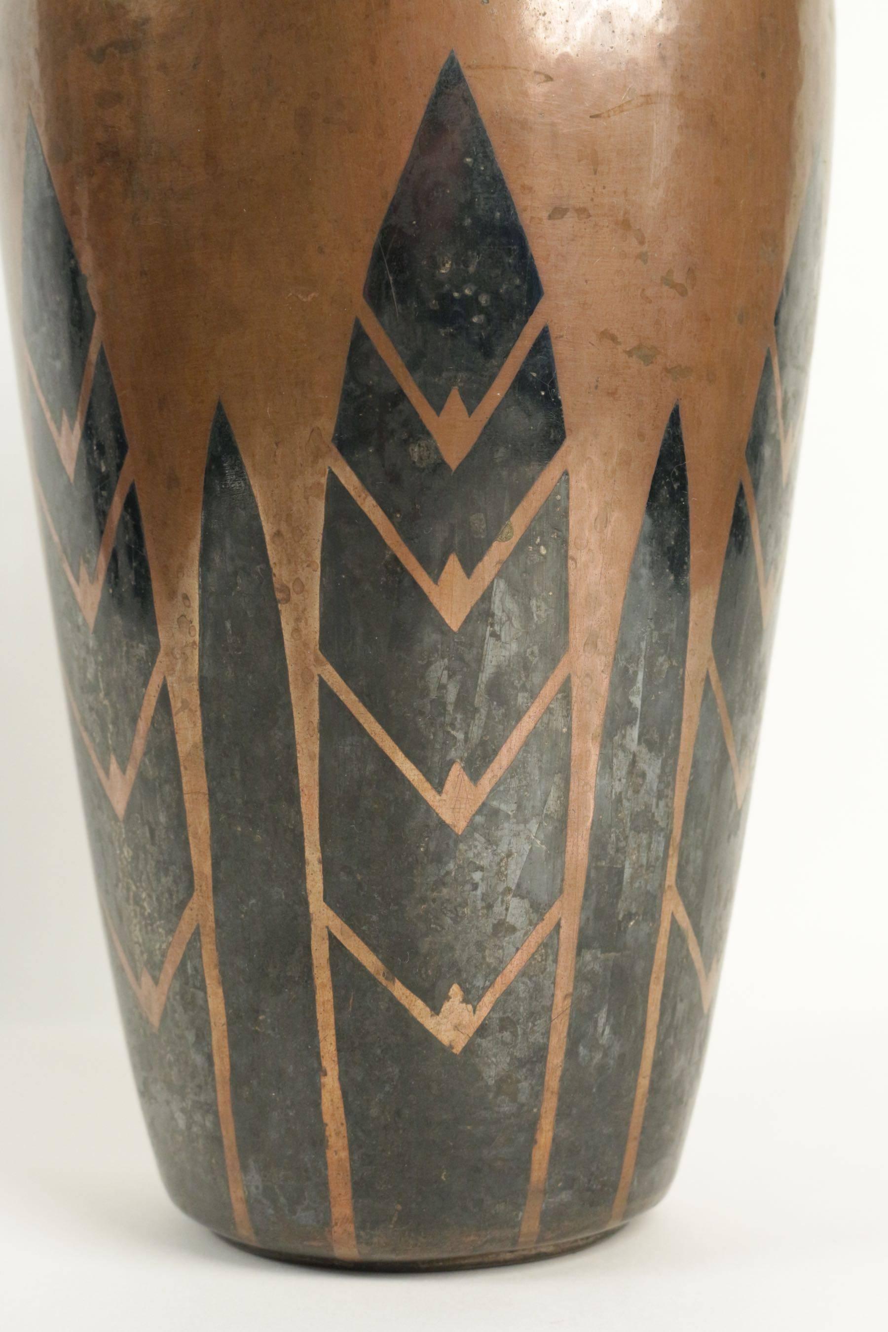 Christofle Travail de Luc Lanel (1893-1965) pour Christofle.
Oval dinanderie vase featuring geometric leaves patterns in copper and silver. “Dinanderie” is a metalworking technique using a single piece of flat metal (copper, brass, silver, tin,