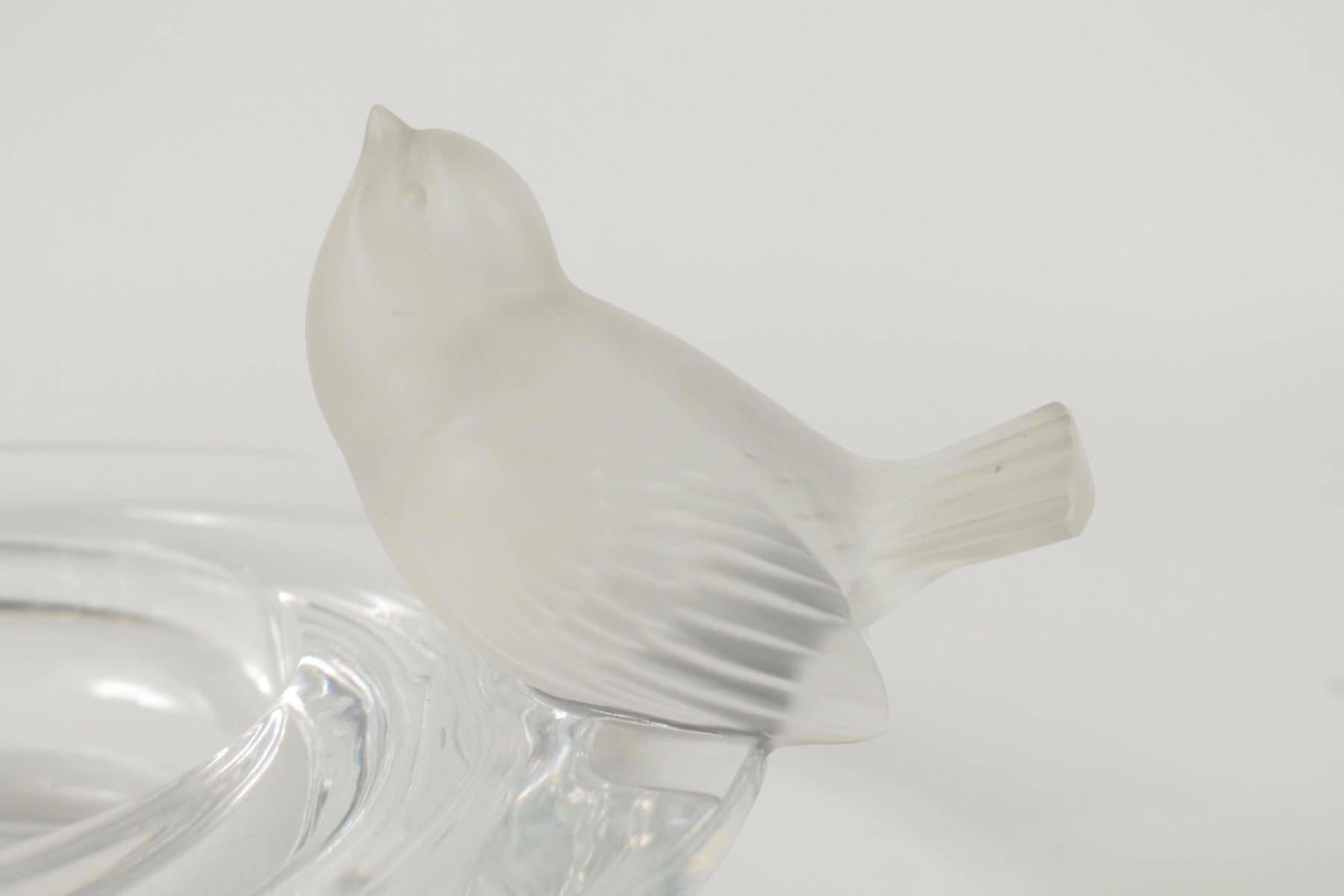Clear glass with broad rim having a bird figure perched on the rim on either side of the bowl
model created in 1929. Measures: 41 cm total width
signed.