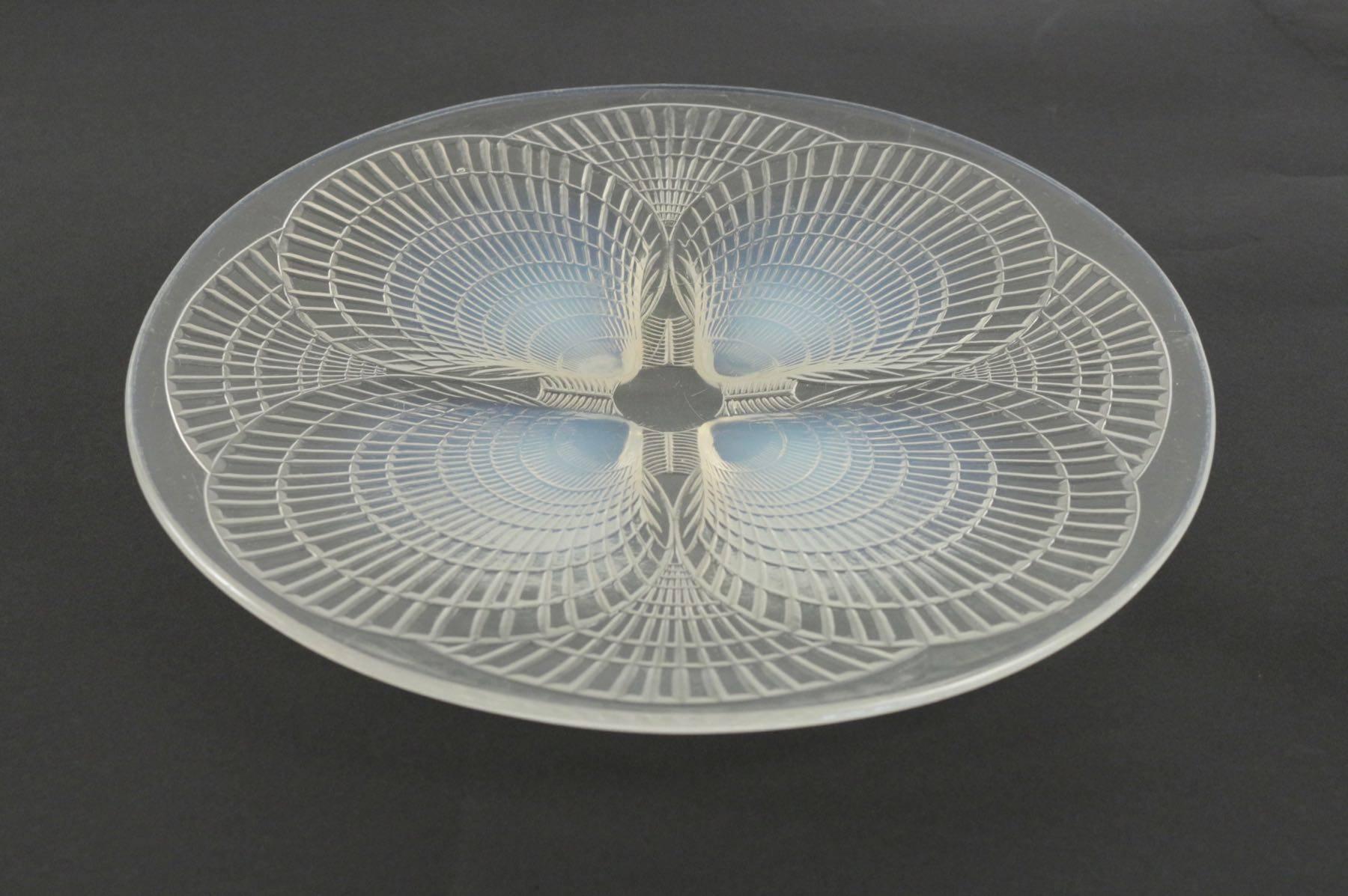 René Lalique (1860-1945) opalescent molded pressed glass Coquilles pattern plate with moulded shell decoration, engraved signature moulded.
'R. Lalique France', 30 cm diameter 
exist in the catalogue in 1928 and 1932 and 1937. 
Bibliography :