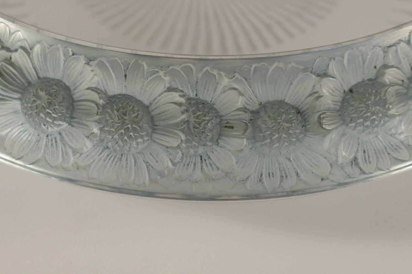 Clear glass with a frosted and blue patinated daisy flower decorated wide rim surrounding the stem decorated
Signed R Lalique, France
Bibliography: Marcilhac model: 10-404 design 1941.