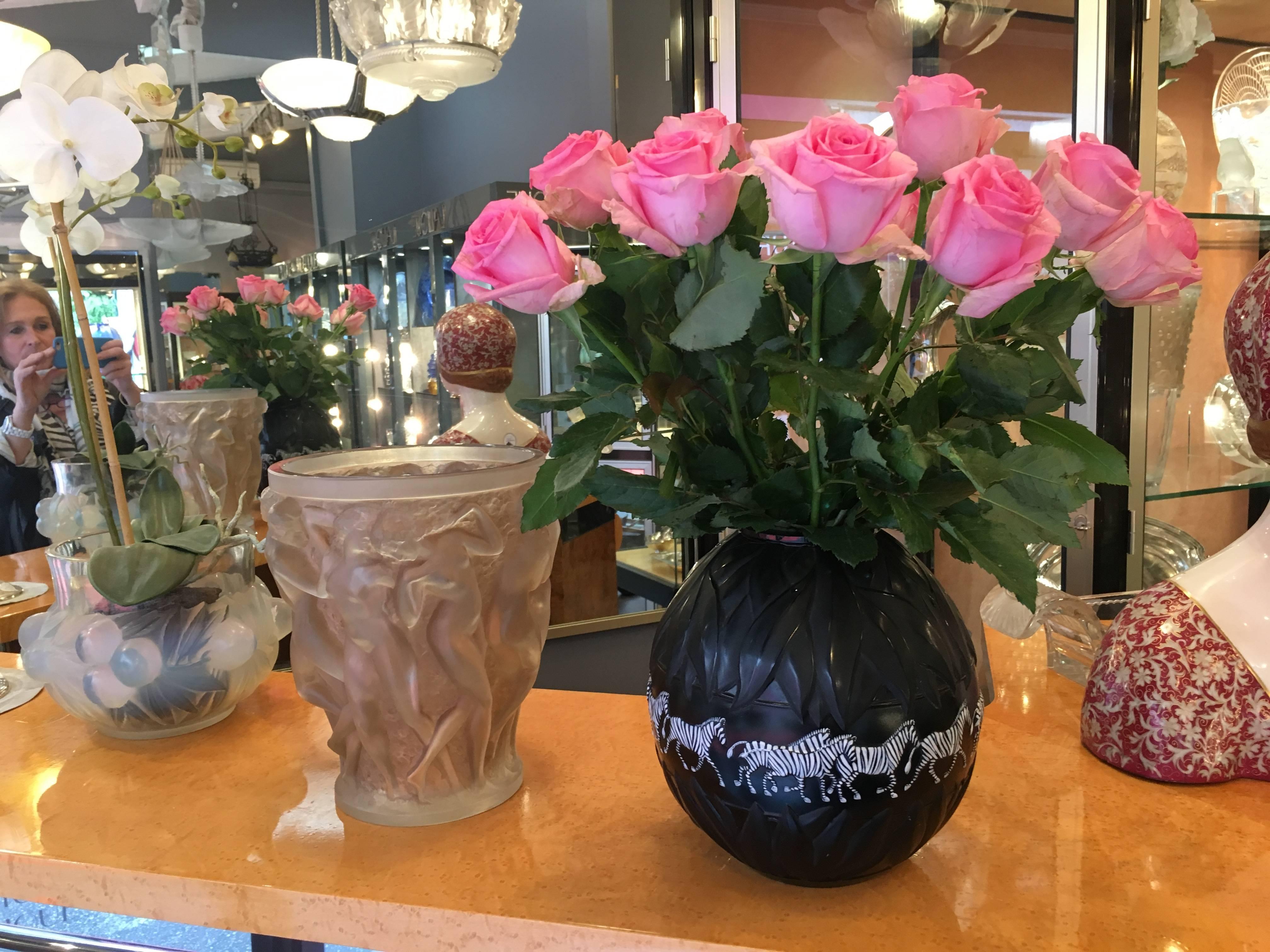 Lalique France.
A Lalique black moulded glass tanzania zebra vase, etched Lalique, france 174, modern
Inspired by the elaborate techniques of her grandfather, Marie-Claude Lalique has created a long, slender-necked vase in black crystal. This