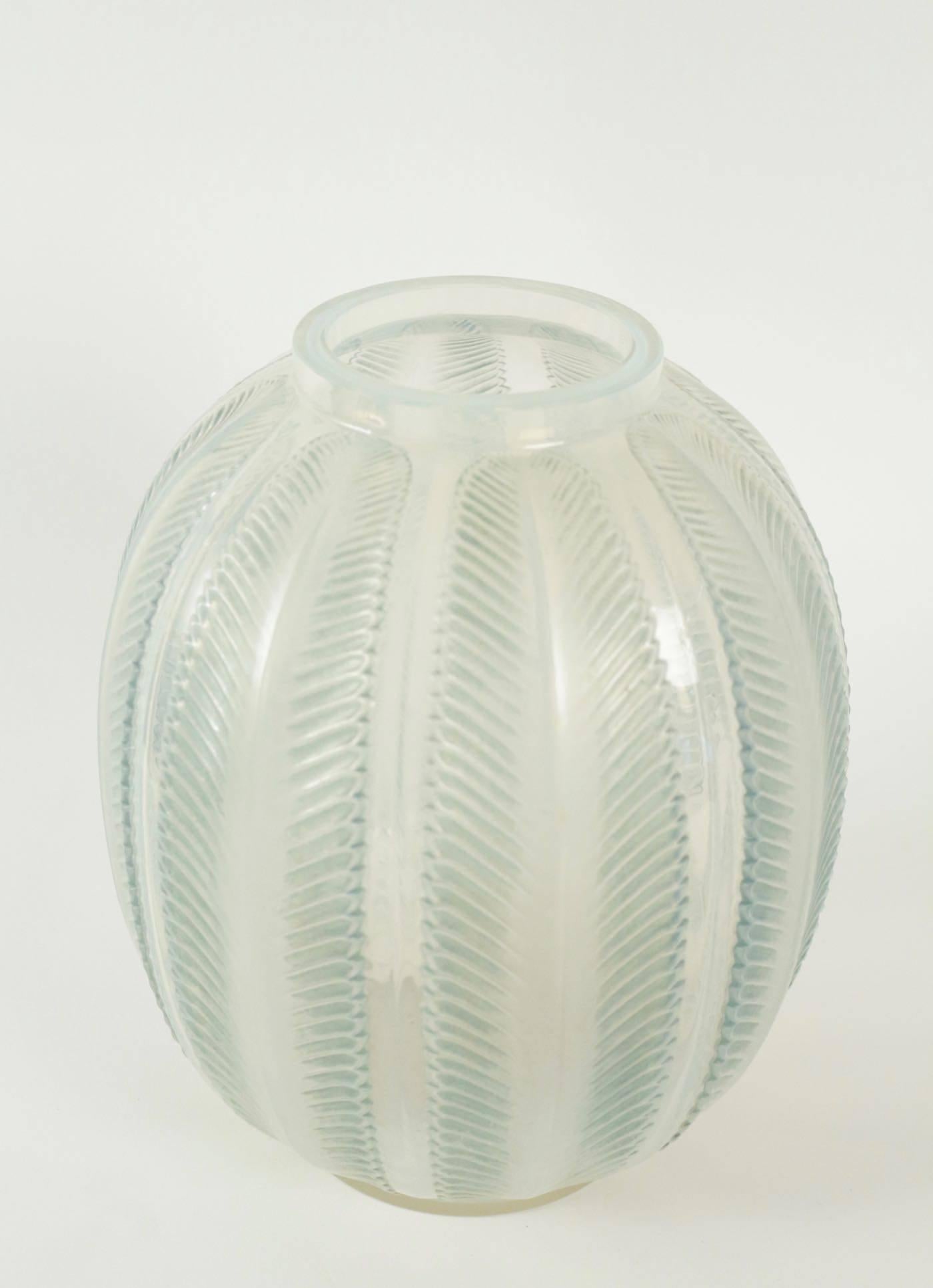 Cased white opalescent and blue patinated palm frond motif glass.
Large palm fronds decorated opalescent glass with vertical palm
René Lalique (1860-1945).
Vase 